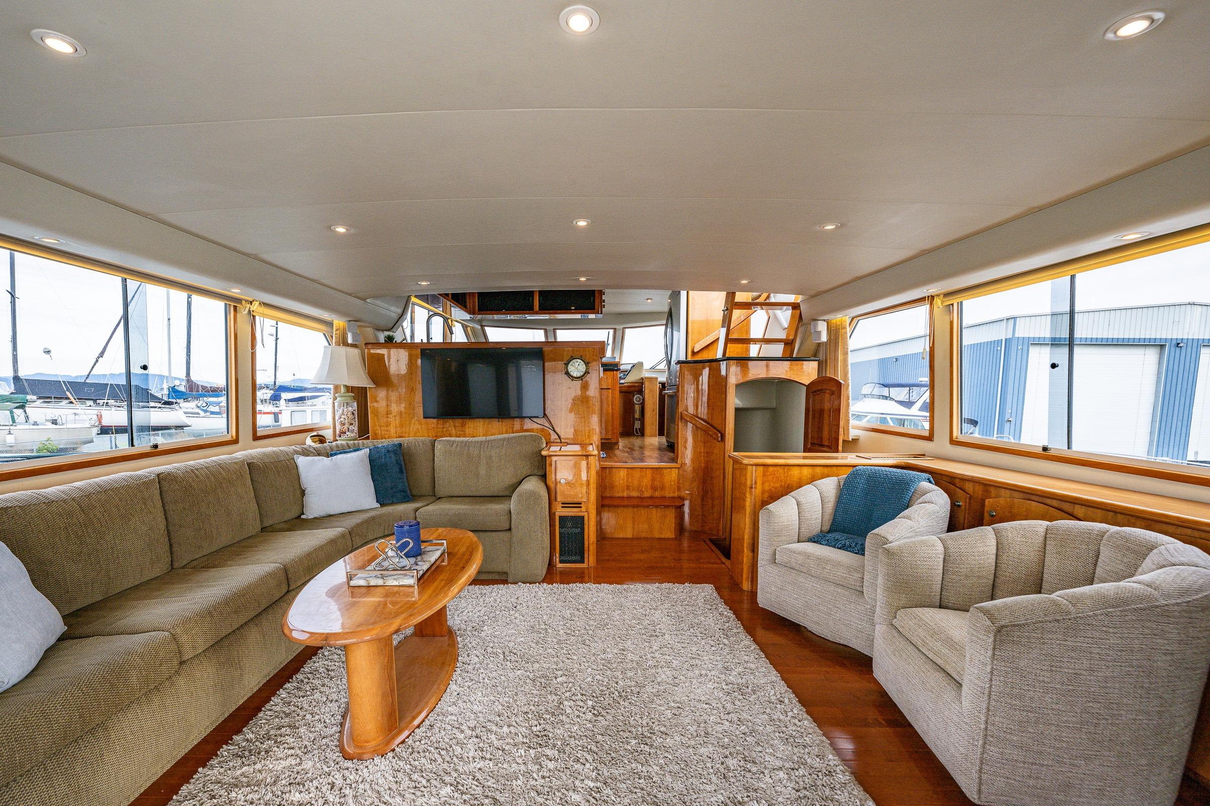 Luxurious 2001 Navigator Pilothouse yacht interior with plush seating and elegant wood finishes.