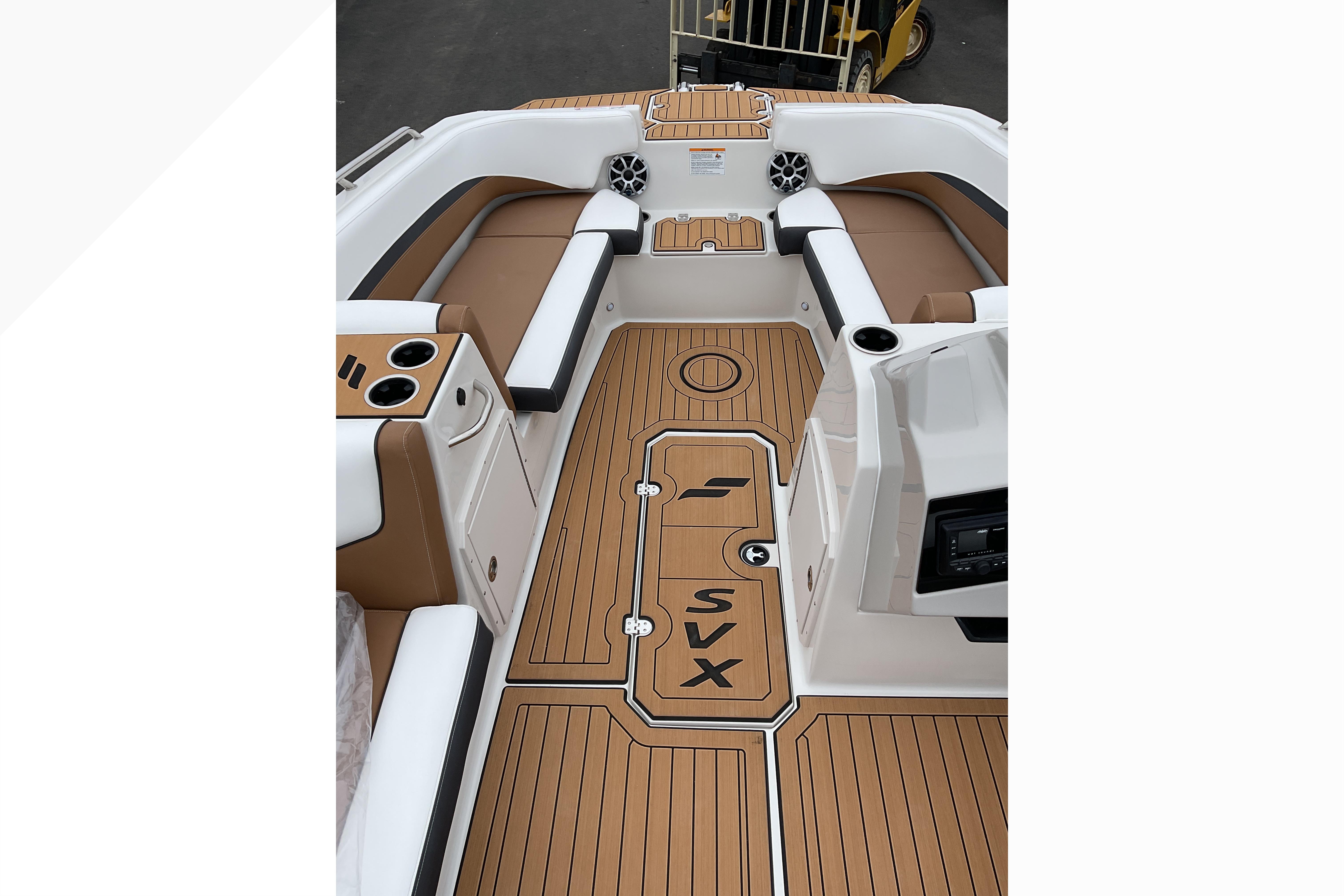 2026 Starcraft SVX 211 OB boat interior with tan seating and wood-patterned flooring.