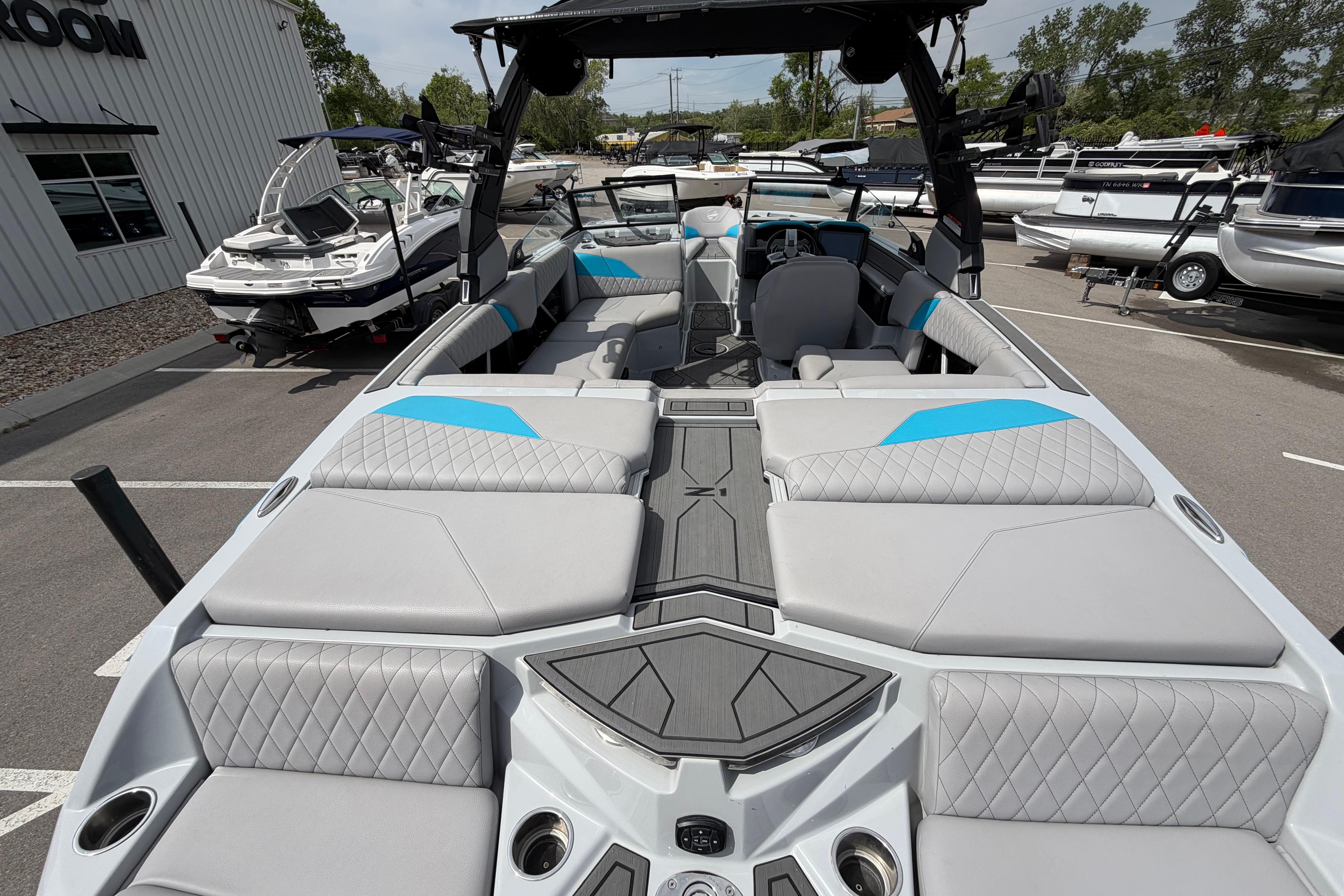 2024 Tigé Z1 boat interior with gray and blue seating, parked outdoors.