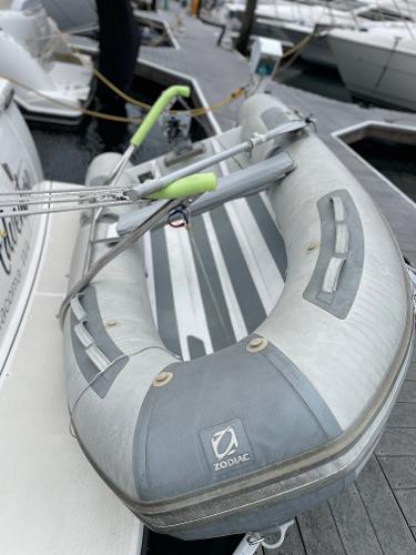 Inflatable Zodiac boat docked beside a 2003 Tiara Yachts 3500 Open.