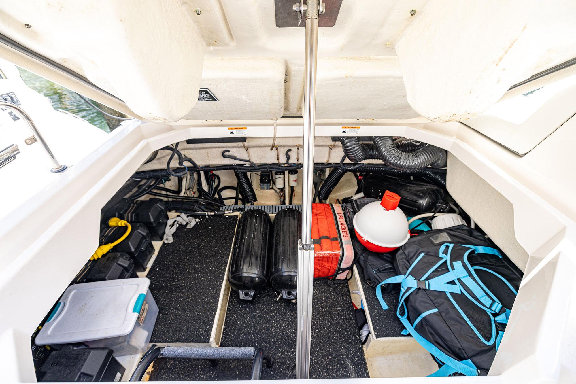 2022 Regal LX36 boat storage compartment with equipment and gear neatly organized.