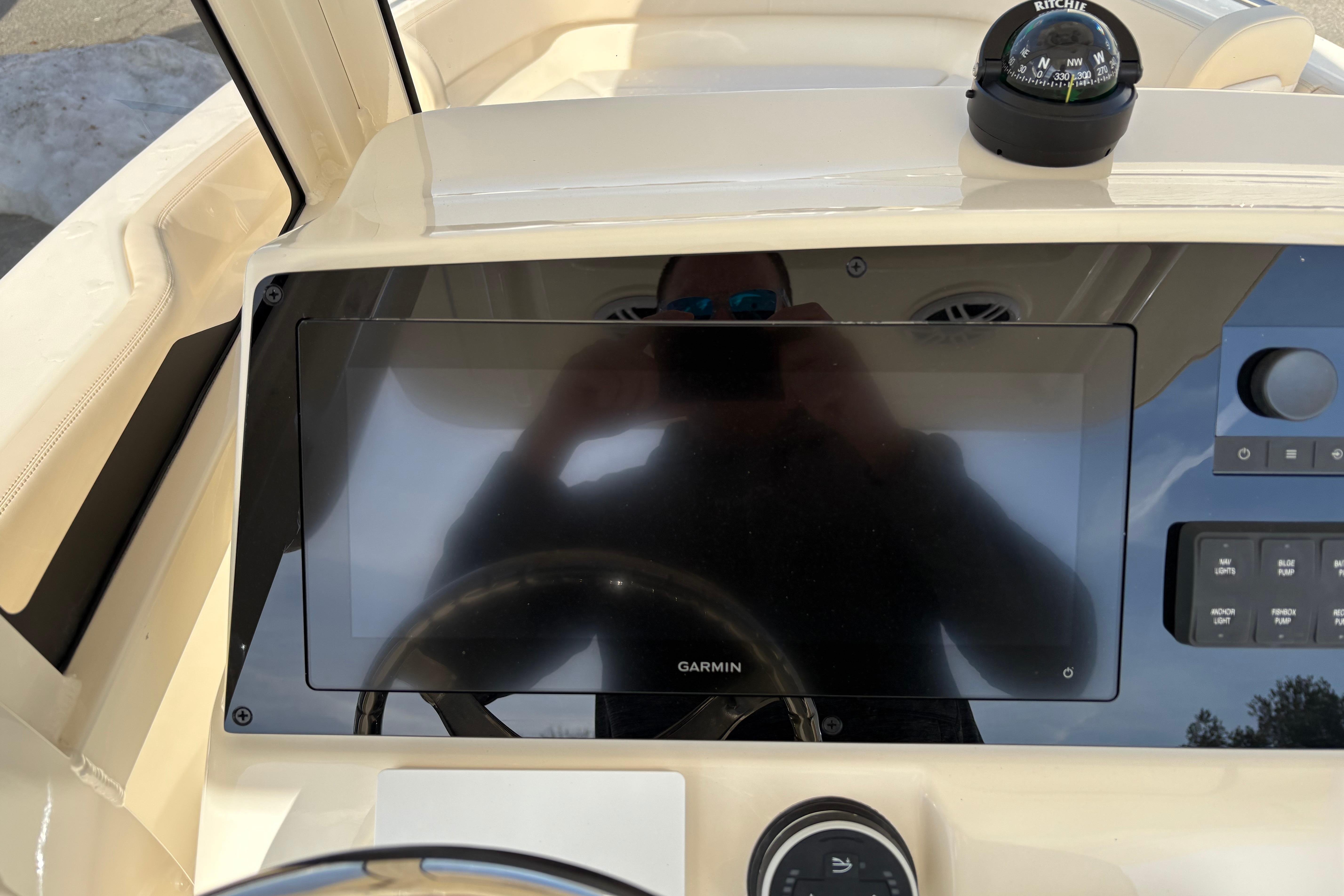 Dashboard of 2026 Scout 220 XSF boat with Garmin display and compass.