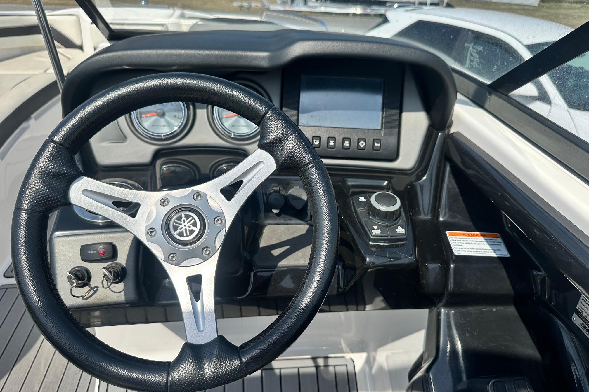 Steering wheel and dashboard of 2016 Yamaha 242 Limited S boat.