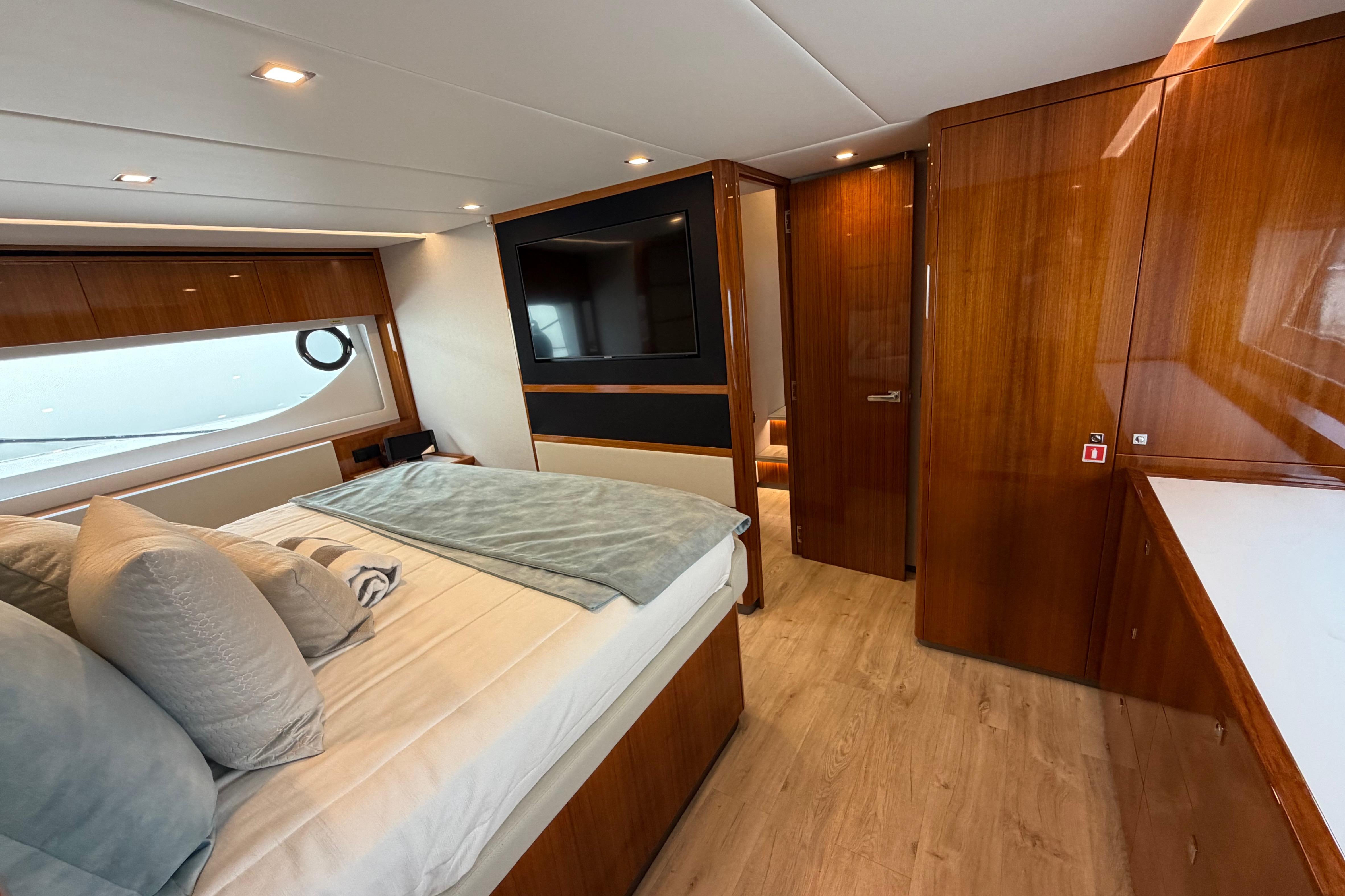 Luxurious interior of 2023 Riviera 645 SUV yacht with elegant wood finishes and modern amenities.