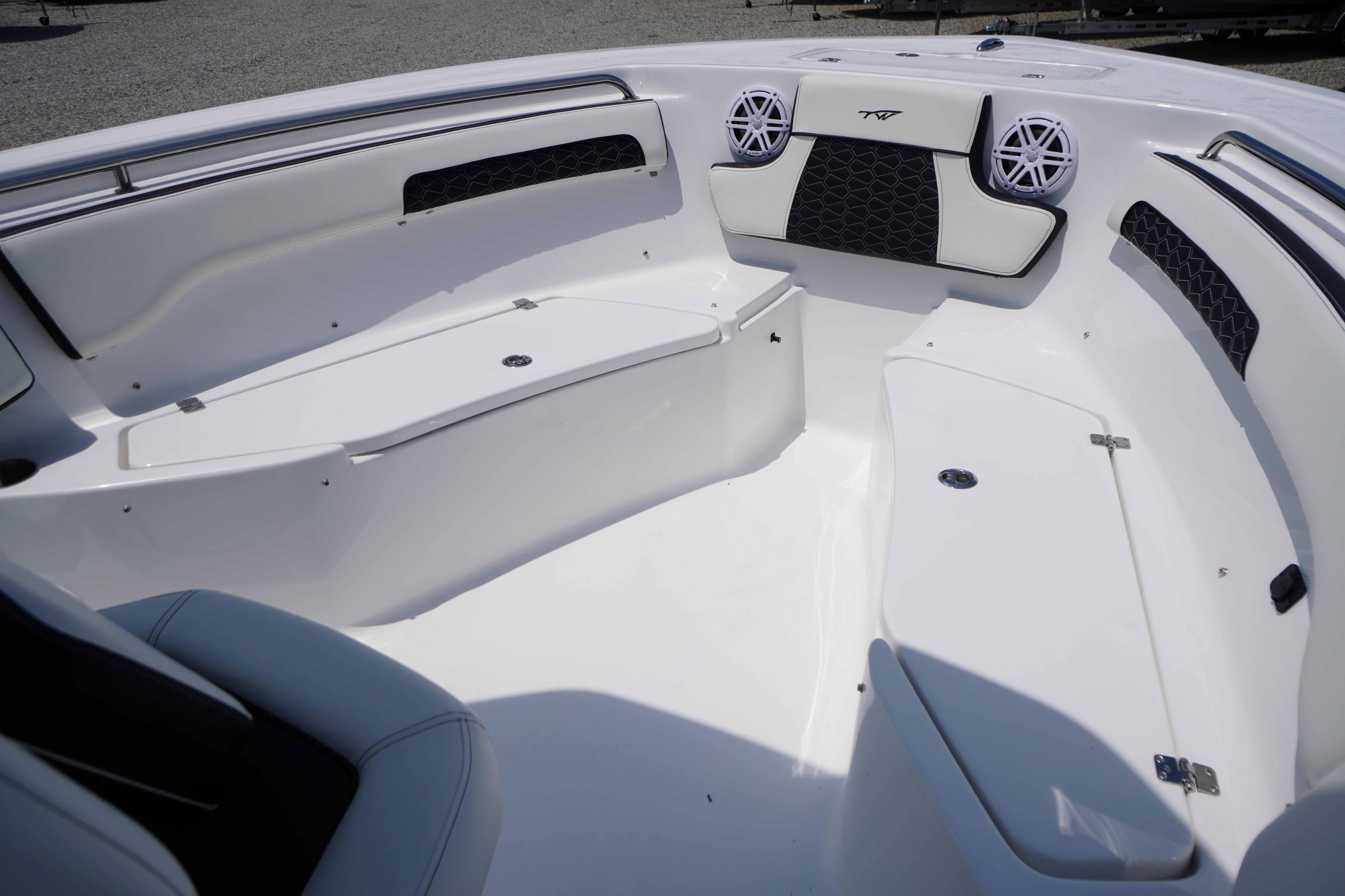 2027 Tidewater 220 CC Adventure boat interior with white seating and speakers.