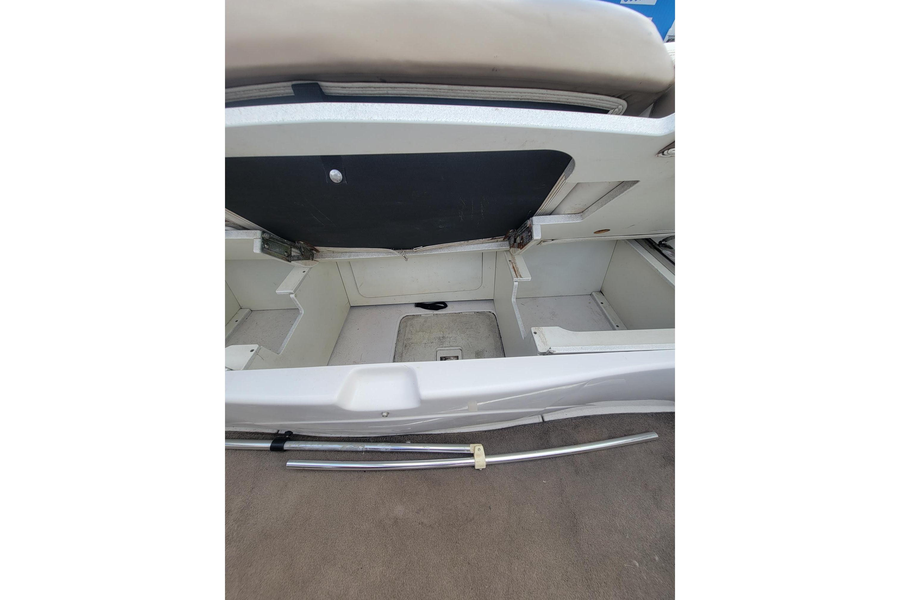 Open storage compartment in 2007 Four Winns 200 Horizon boat, showcasing interior space.