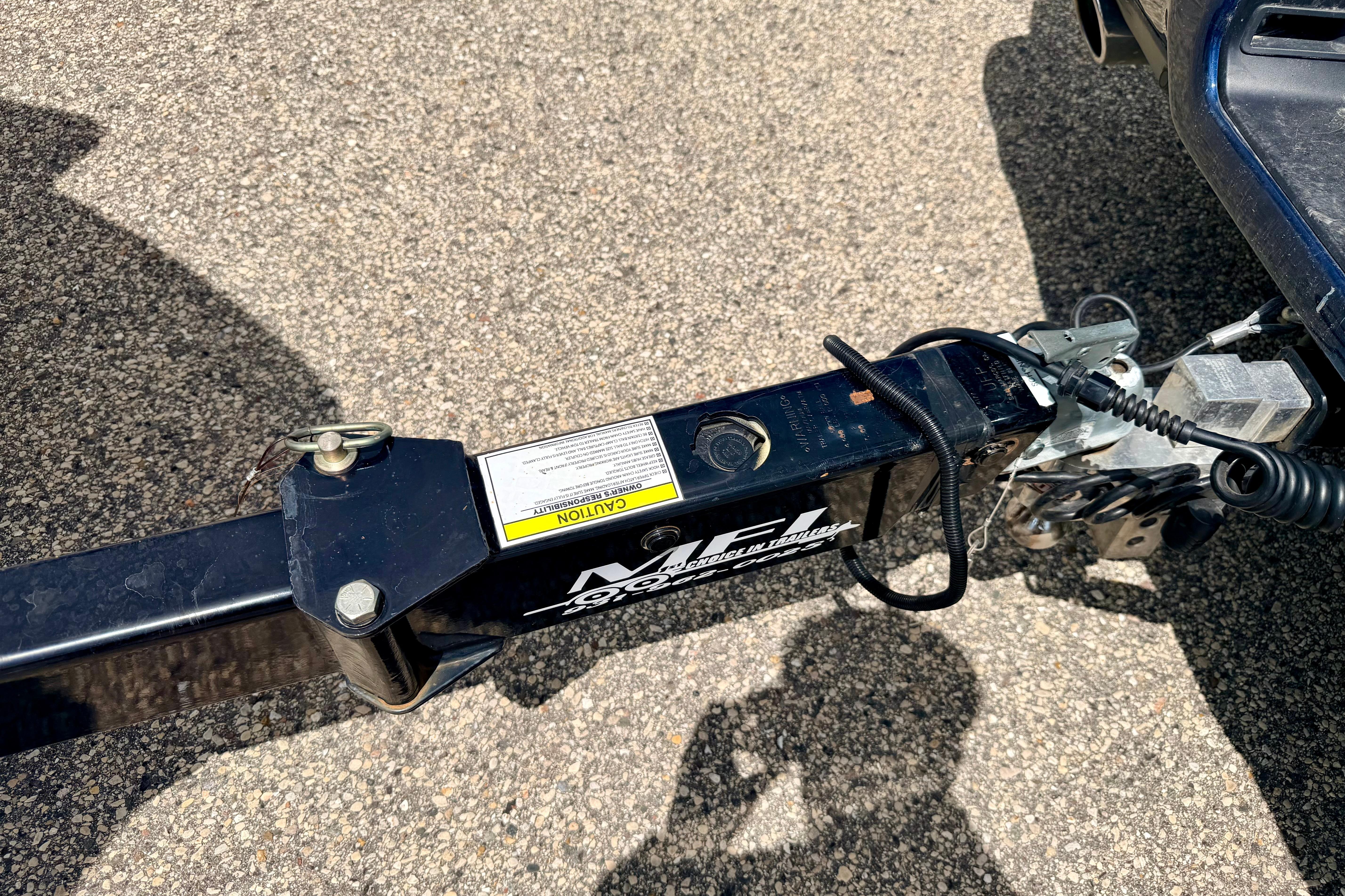 Trailer hitch of a 2015 Chaparral Sunesta 264 on asphalt surface.
