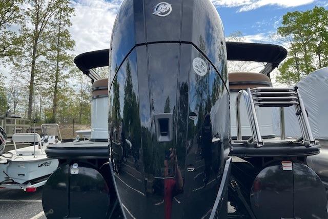 2026 Regency 250 DL boat with powerful outboard motor, parked outdoors.