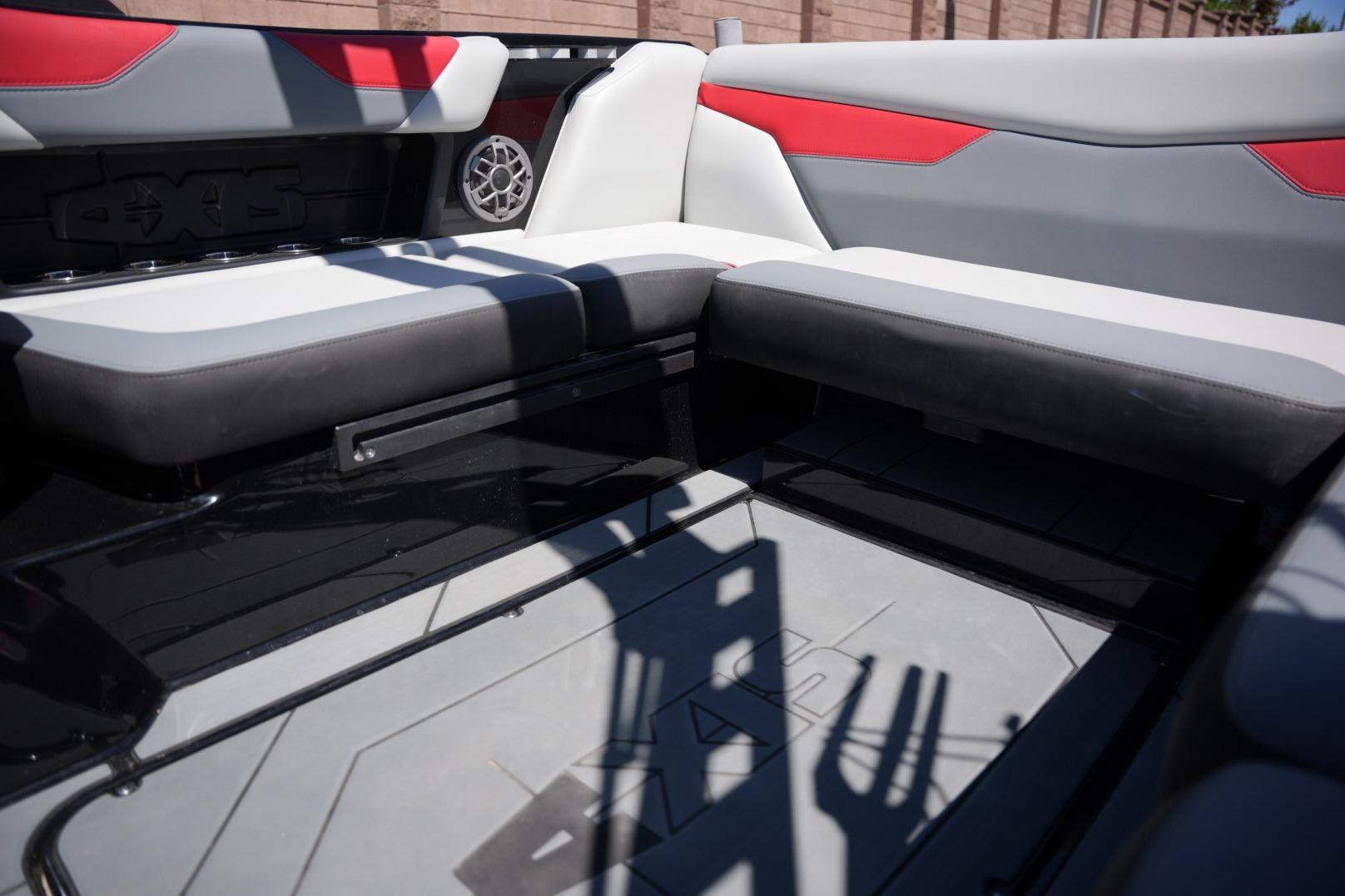 Interior of a 2019 Axis A22 boat with gray and red seating.