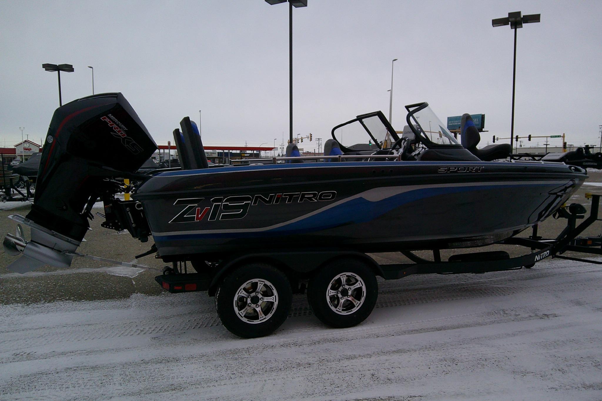 2026 Nitro ZV19 Sport Pro boat on trailer in snowy parking lot.