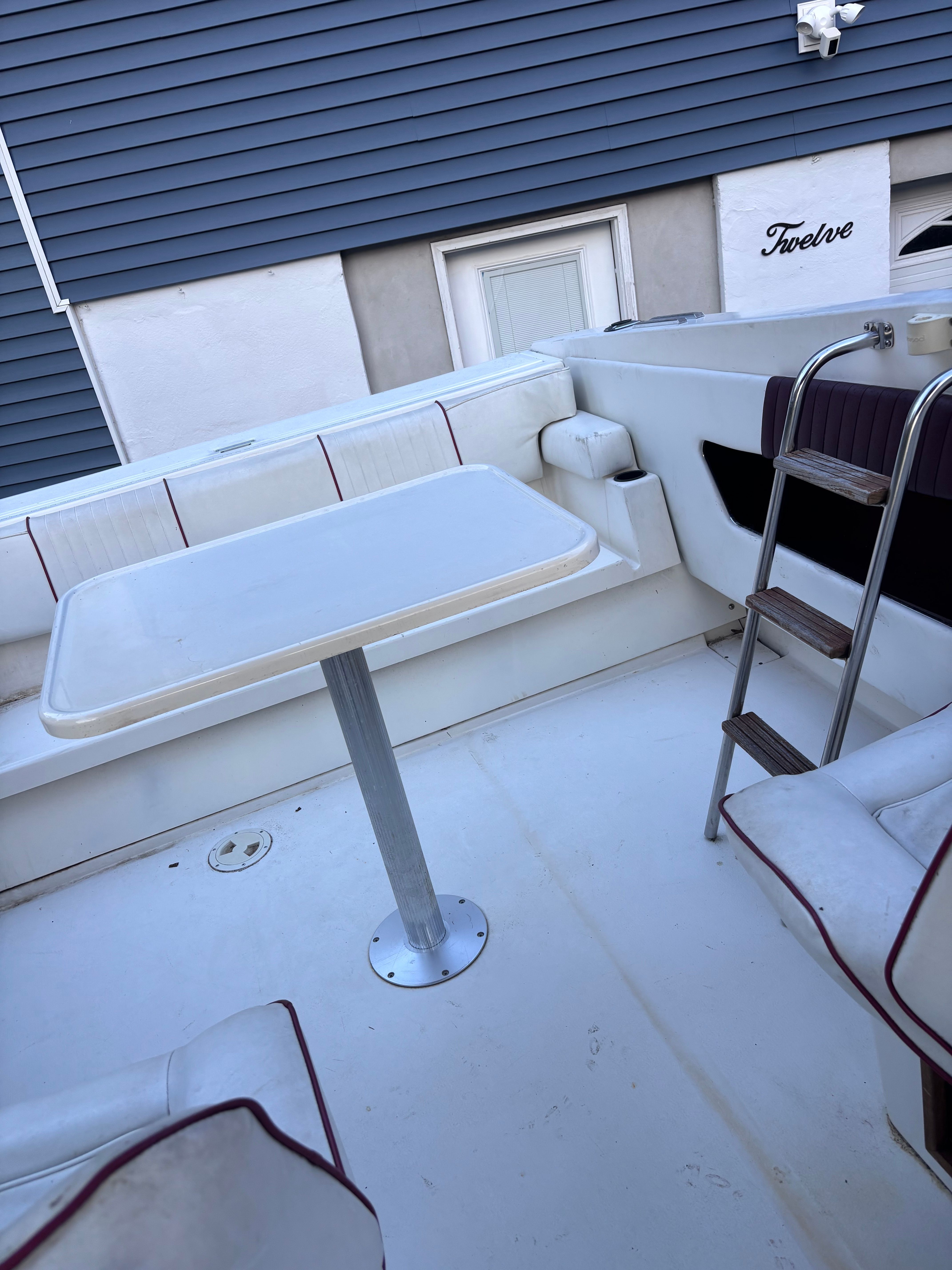 The image shows the cockpit of a 1989 Sea Ray Sundancer with a table and seating.