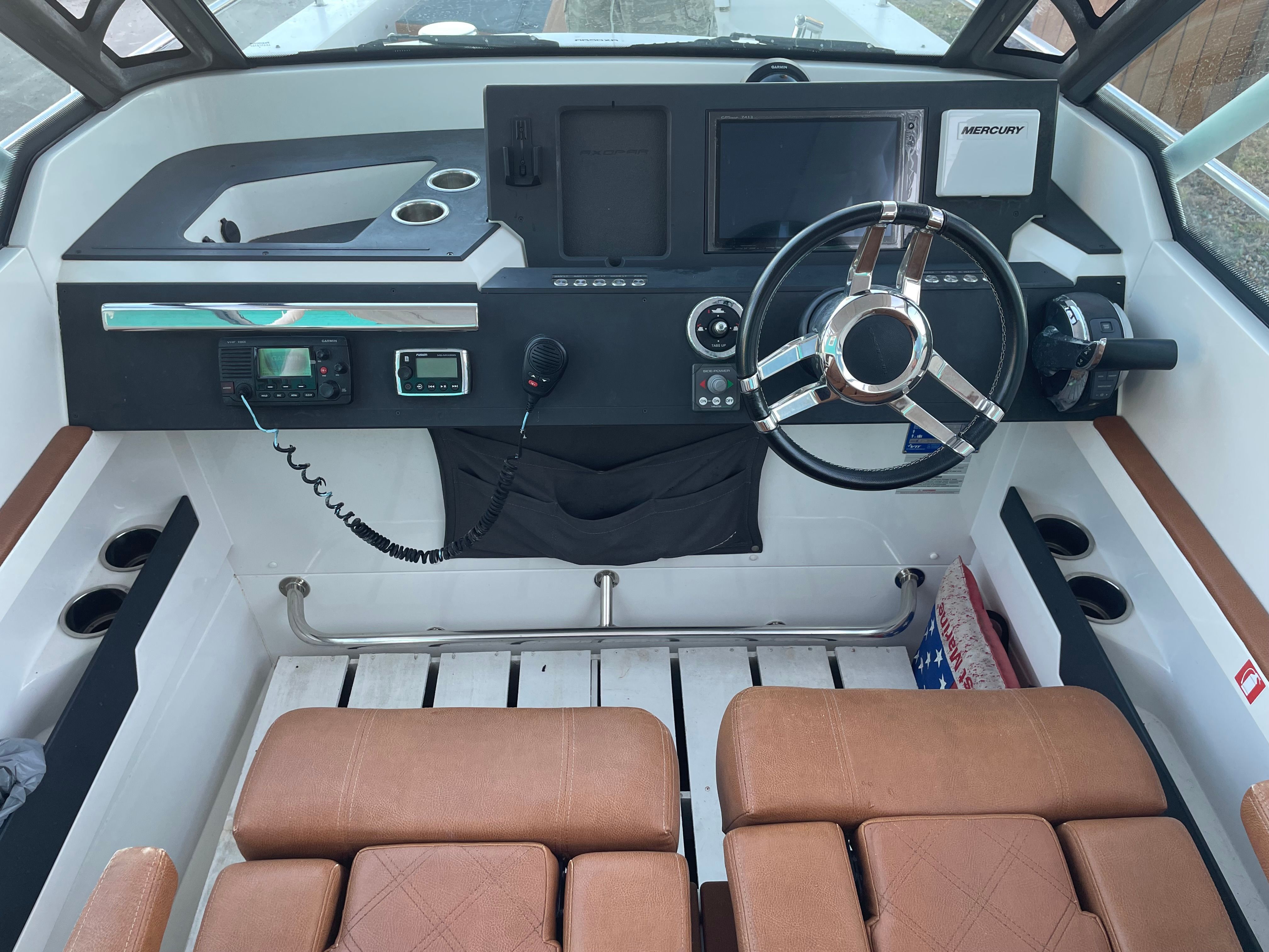 Interior view of 2018 Axopar 28 T-Top cockpit with controls.