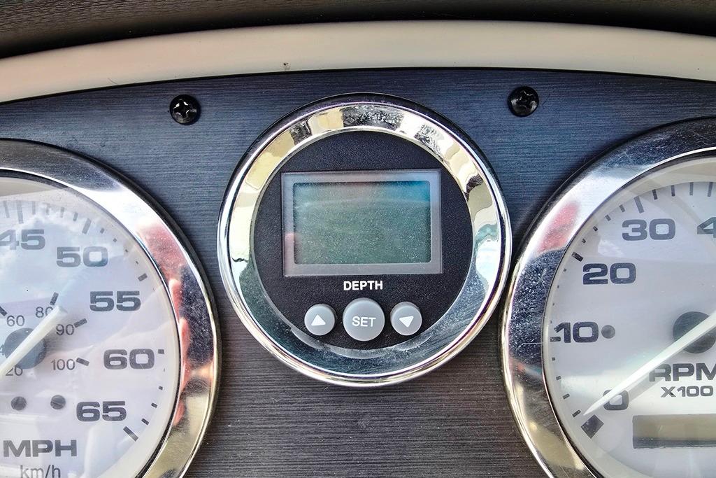 Dashboard of a 2006 Sea Ray 185 Sport boat with depth gauge and speedometer.