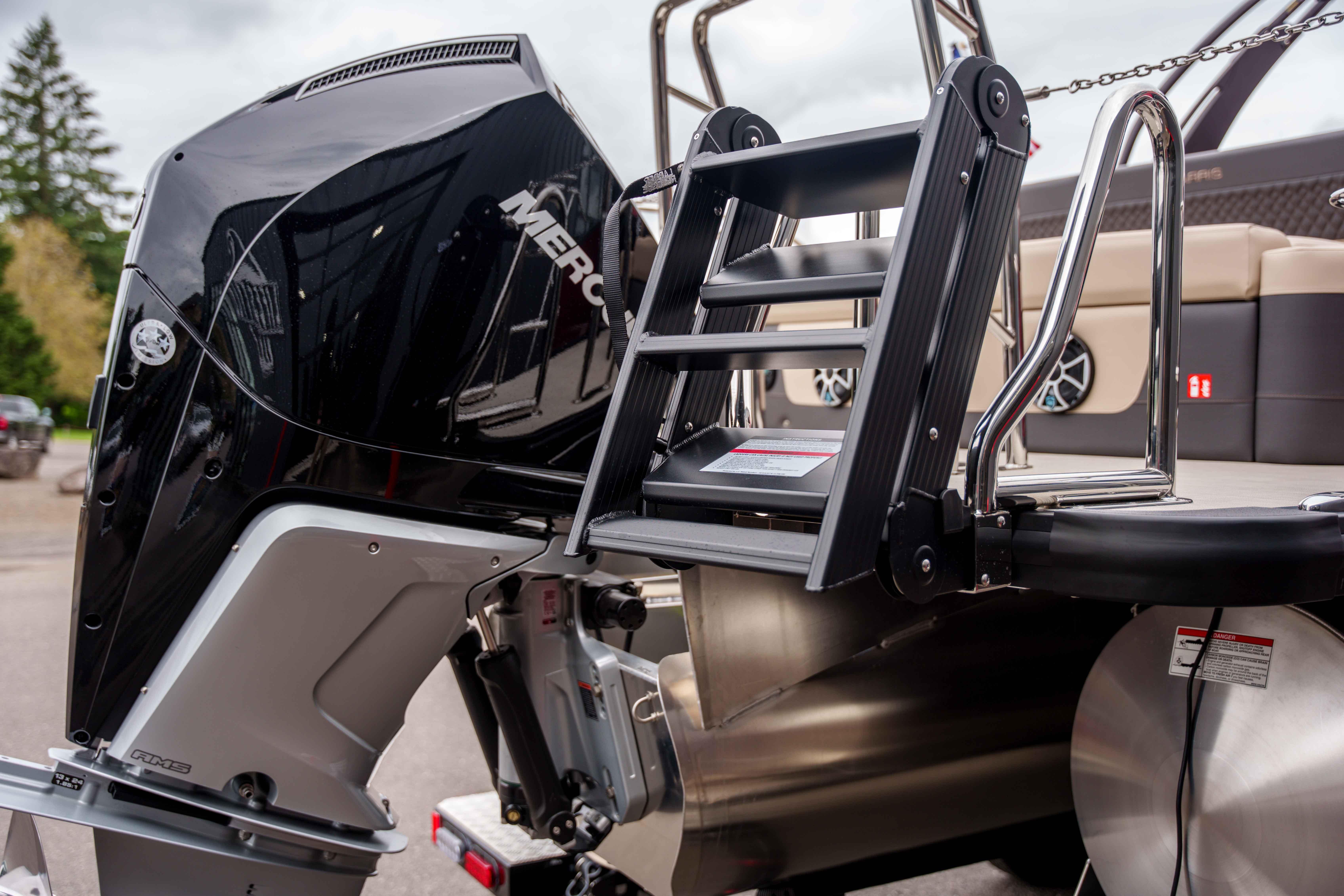 2026 Harris Sunliner 230 boat with Mercury outboard motor and swim ladder.