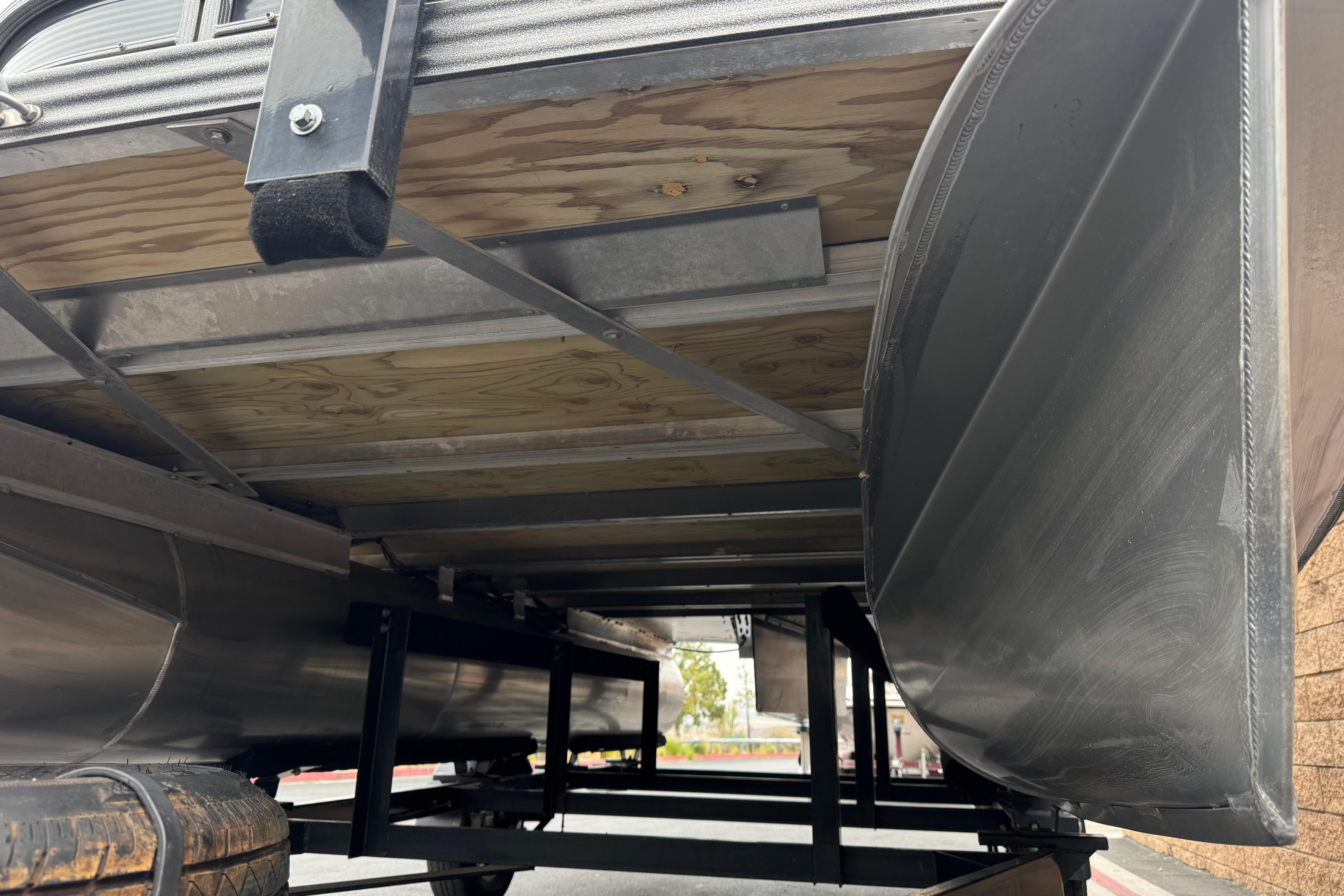 Underside view of 2020 Manitou 18 Aurora LE pontoon boat on trailer.