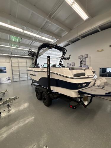2025 MasterCraft XT22 boat in showroom, featuring sleek design and modern features.