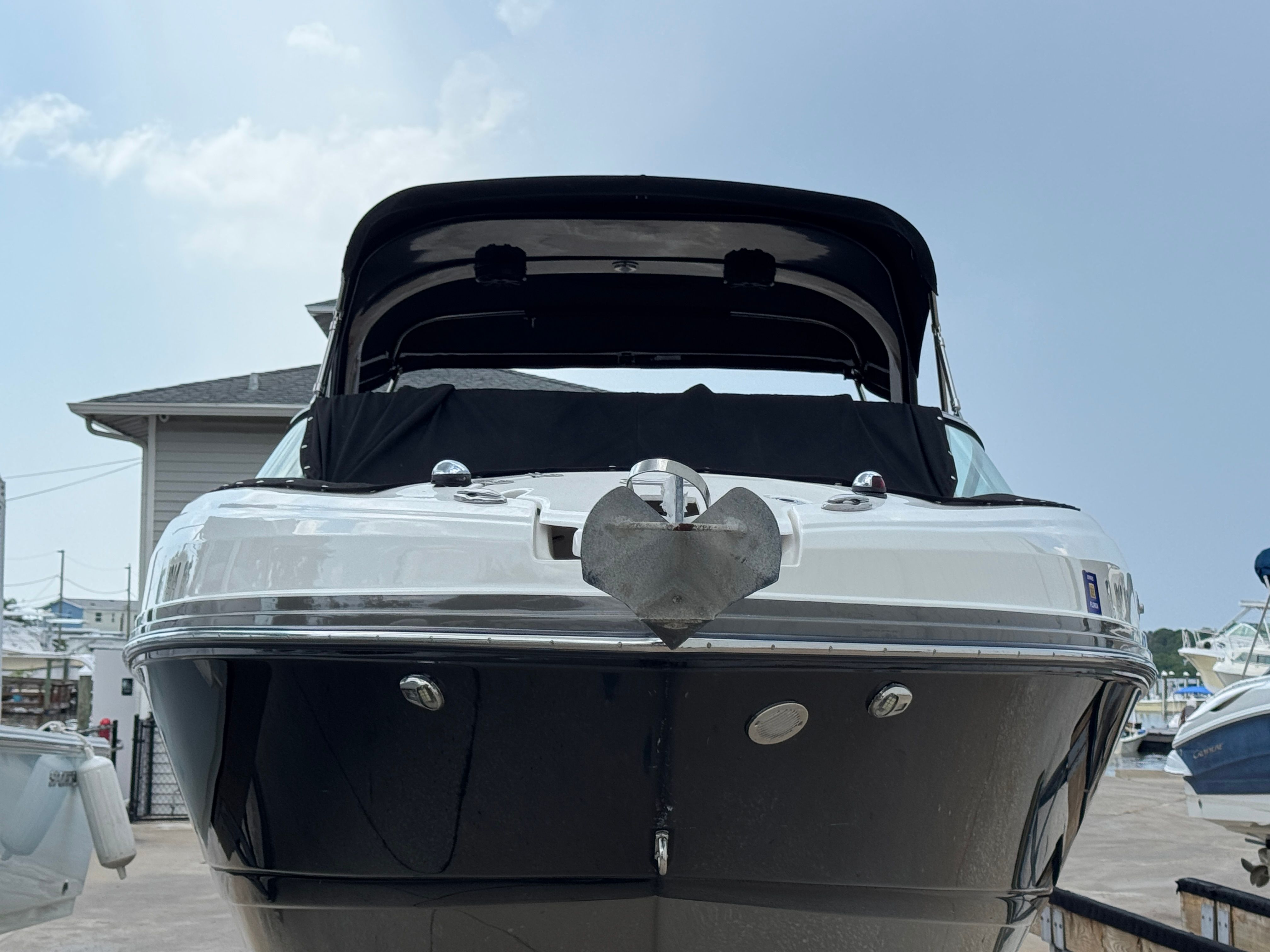 2017 Rinker QX29 BR boat, front view at the dock.