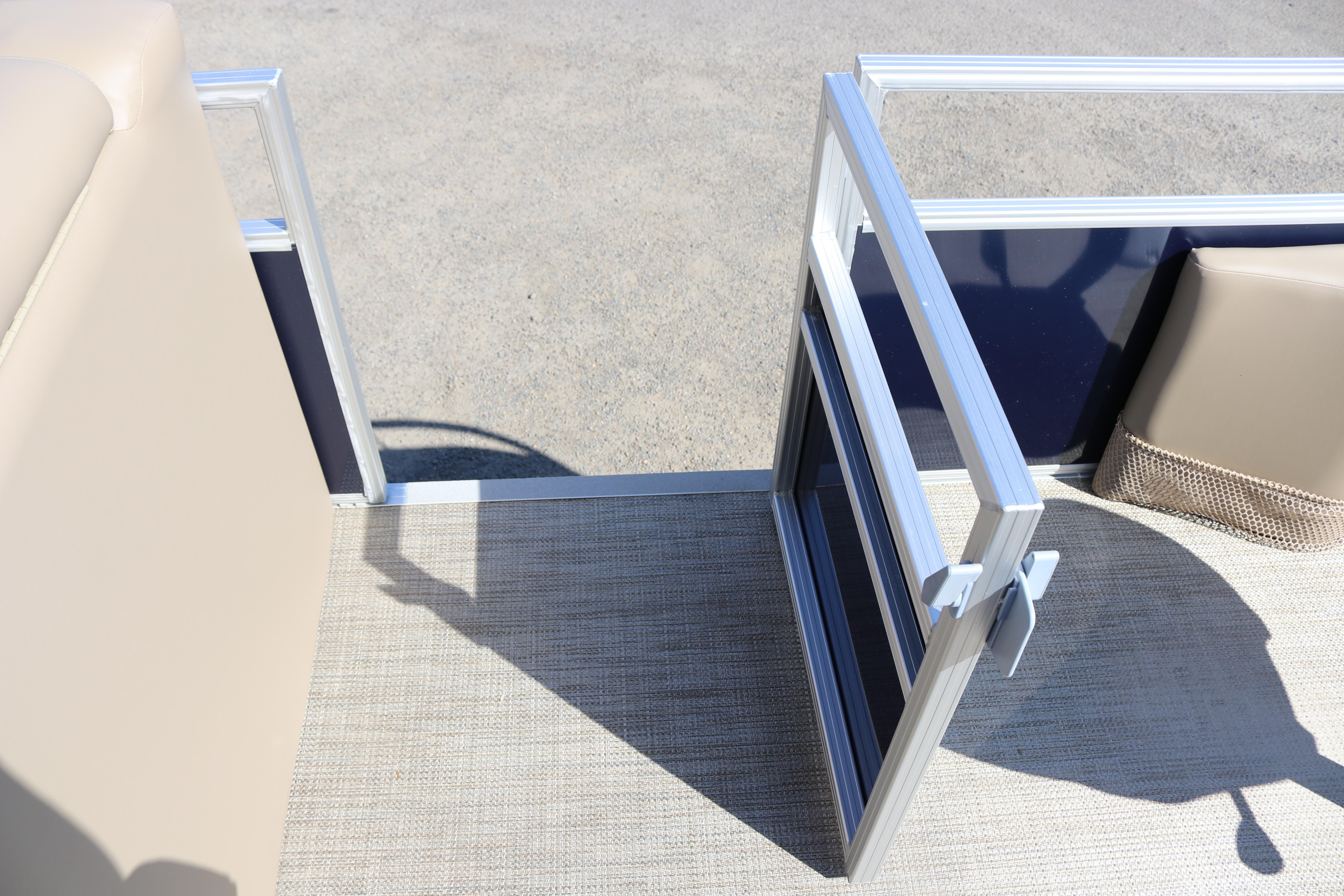 Open gate on 2025 Sun Chaser Vista Fish 18 pontoon boat, beige and blue interior.