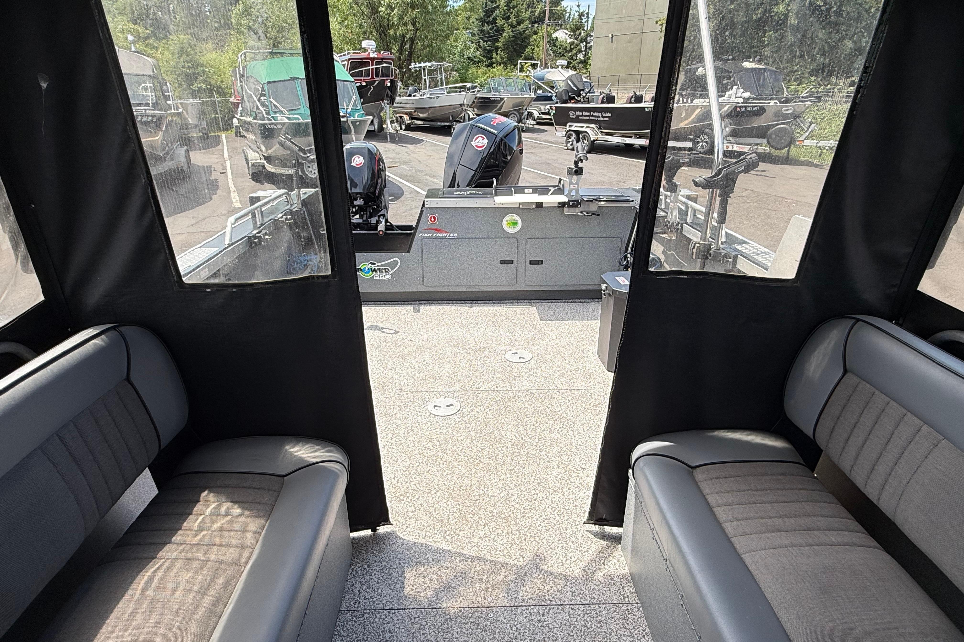 Interior view of 2019 Alumaweld Intruder Hard Top 22' boat with seating and motor.