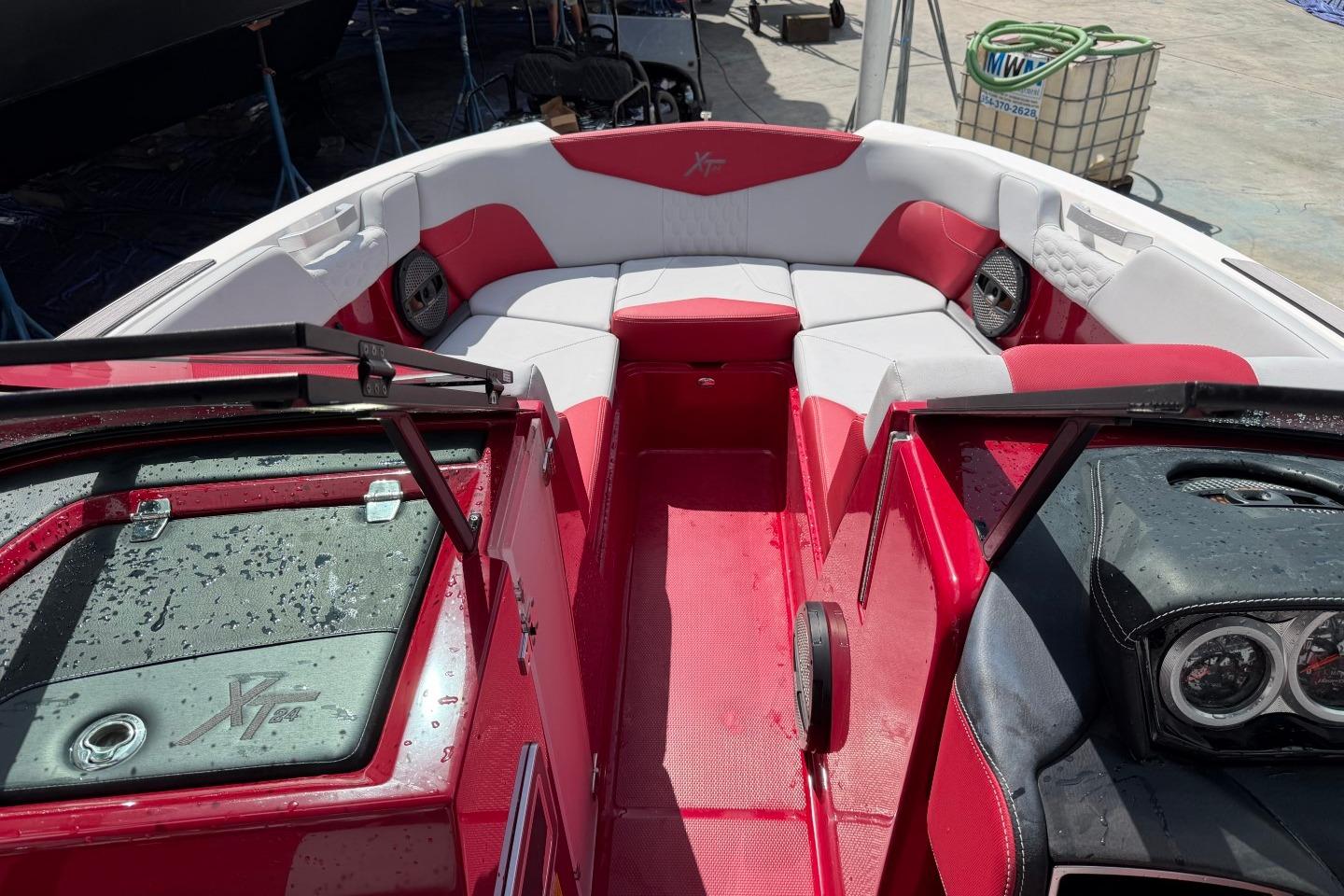 2023 MasterCraft X24 boat interior with red and white seating and dashboard.