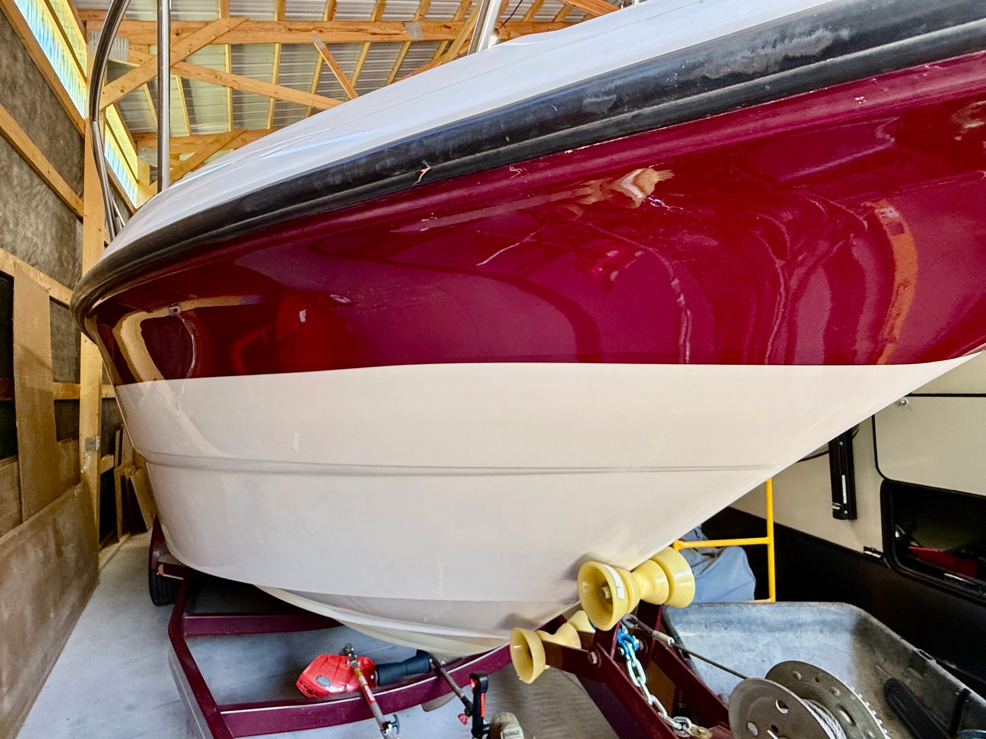 A 1997 Chaparral Signature 260 is stored in a warehouse on a trailer.