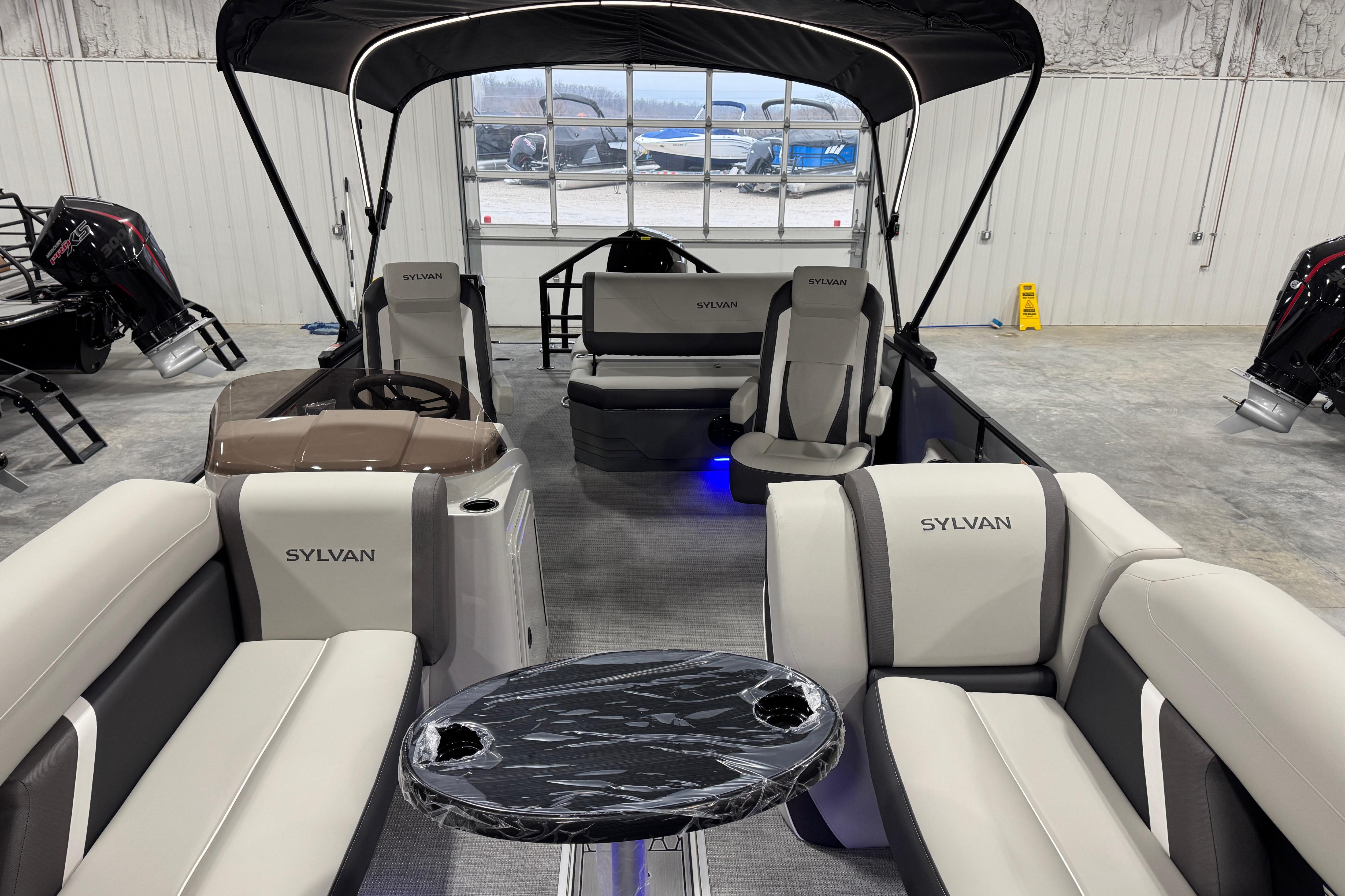 2026 Sylvan X5 boat interior with modern seating and sleek design in a showroom.