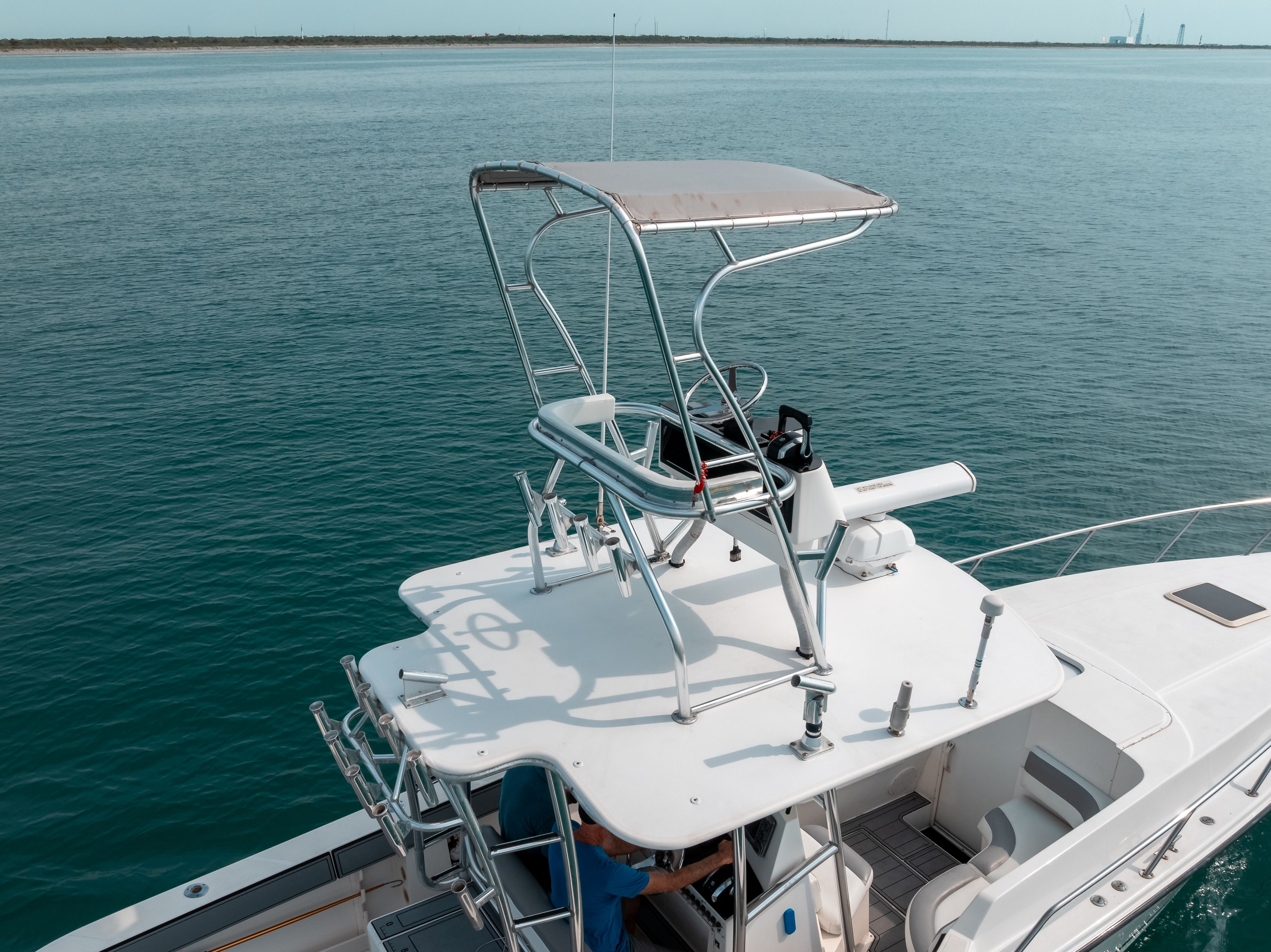 A 2006 Tempest Offshore 40 with an elevated helm station on calm water.