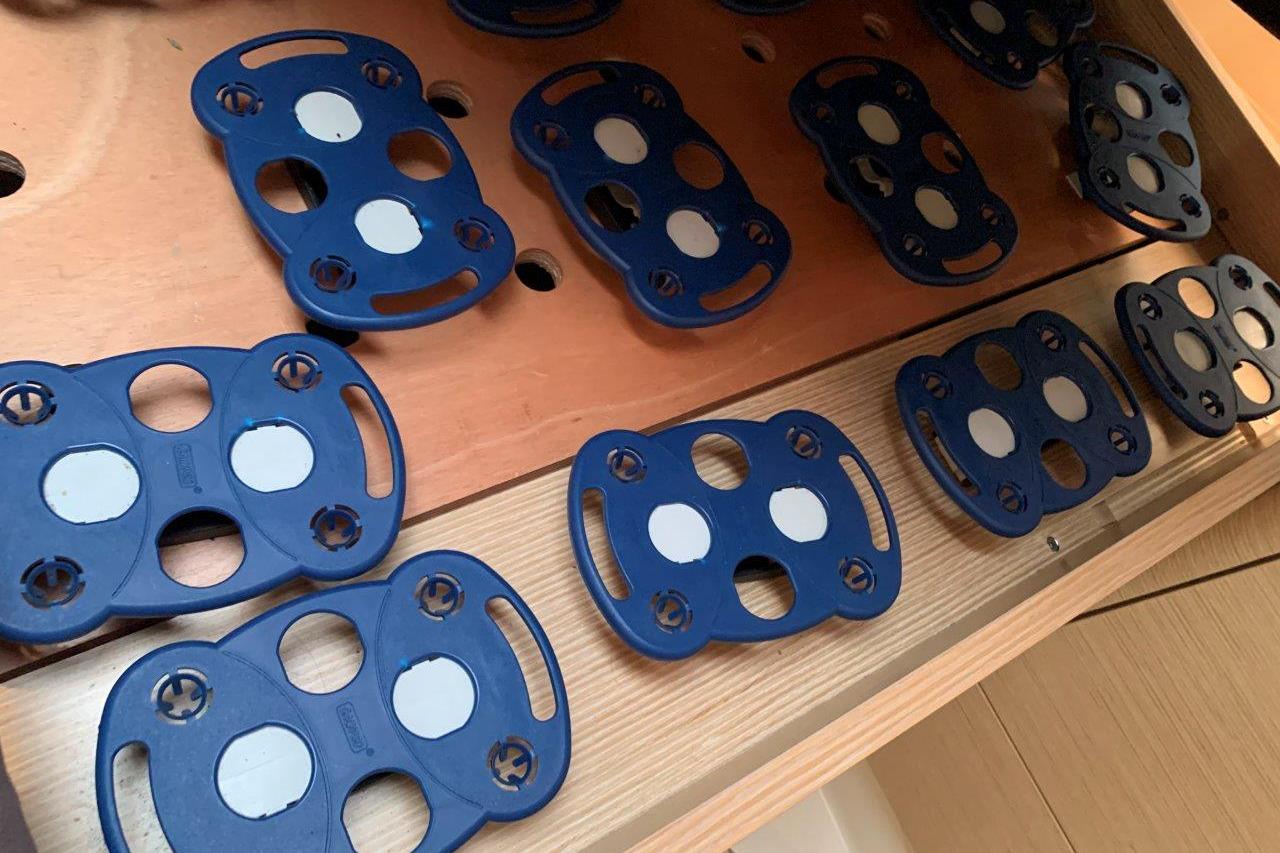 Blue plastic components on a wooden surface, possibly part of a Hanse 348 boat interior.