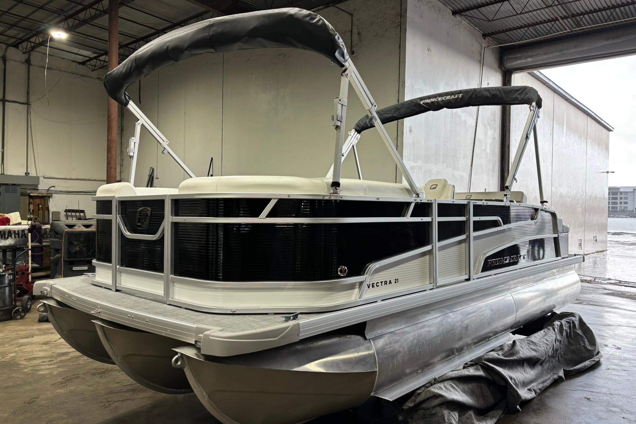 2025 Princecraft Vectra 21 RL pontoon boat in a warehouse setting.