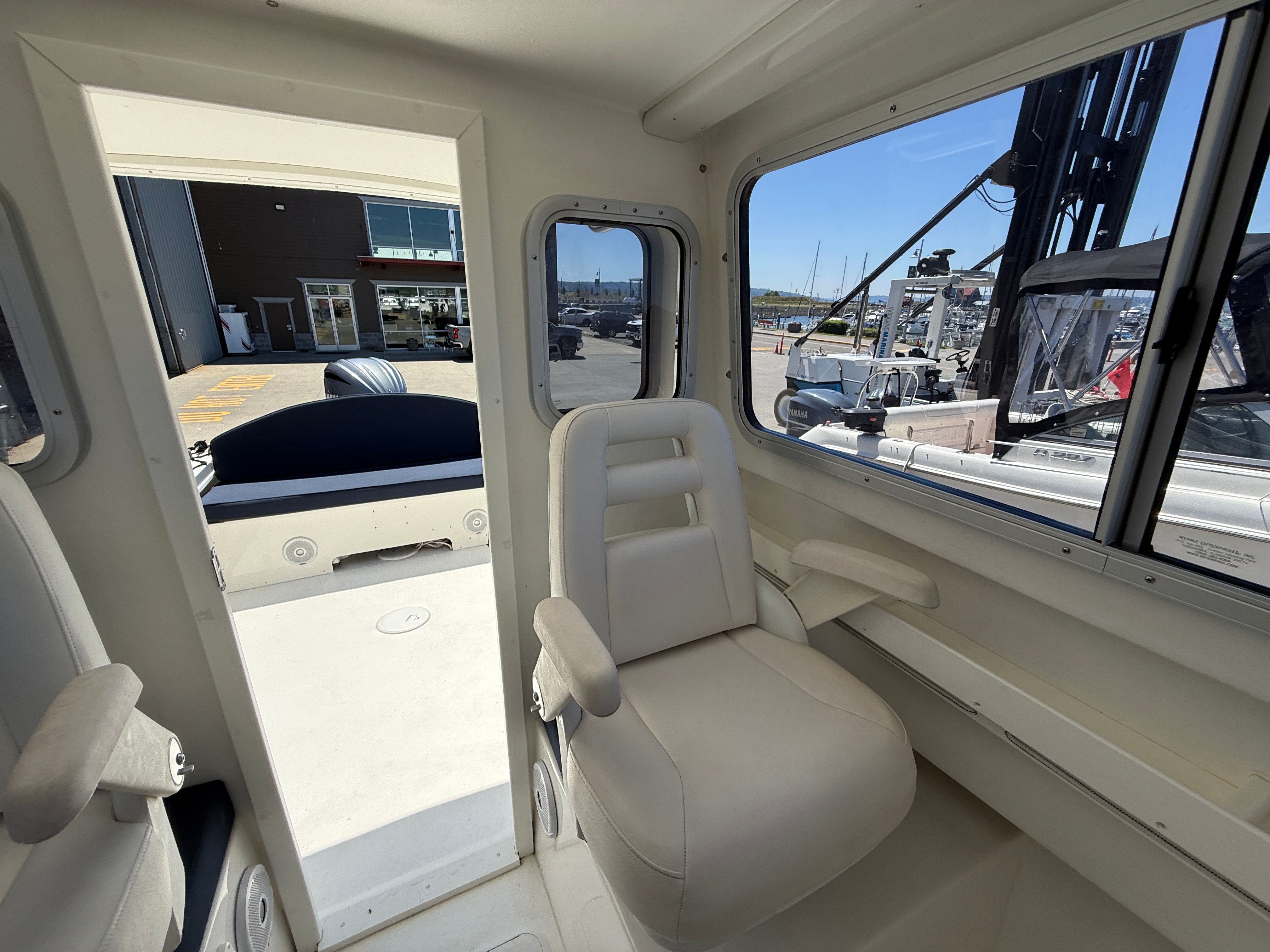 Interior view of a 2015 Steiger Craft 255 Chesapeake with comfortable seating and large windows.