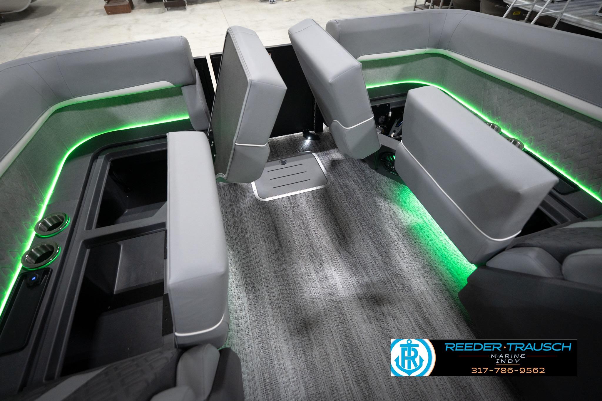Interior of 2026 Bennington 24 MFB boat with green LED lighting and gray seating.