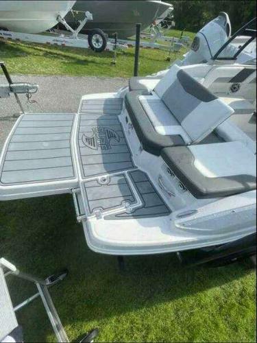 2022 Chaparral 23 Surf boat with sleek seating and swim platform.