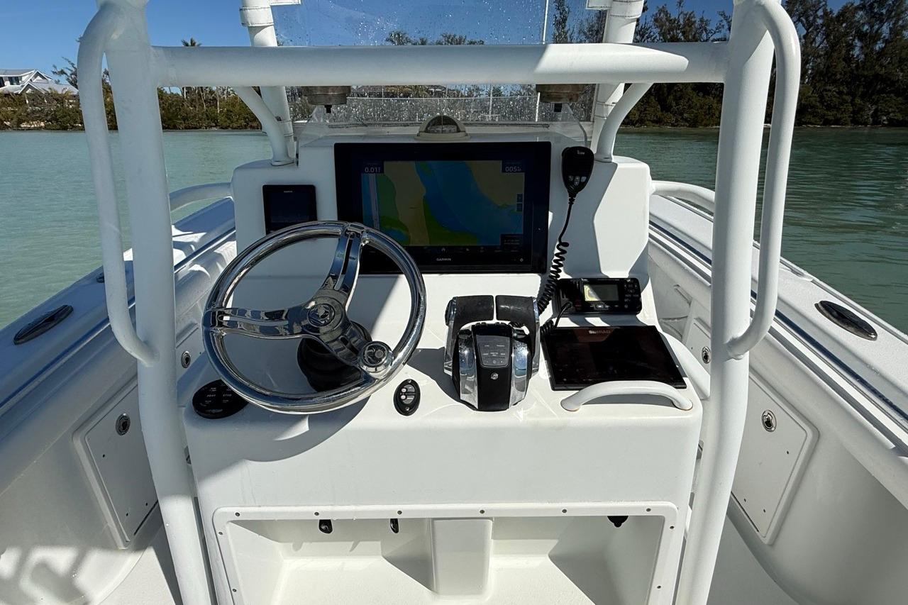 2017 Yellowfin 26 Hybrid boat console with steering wheel and navigation equipment.