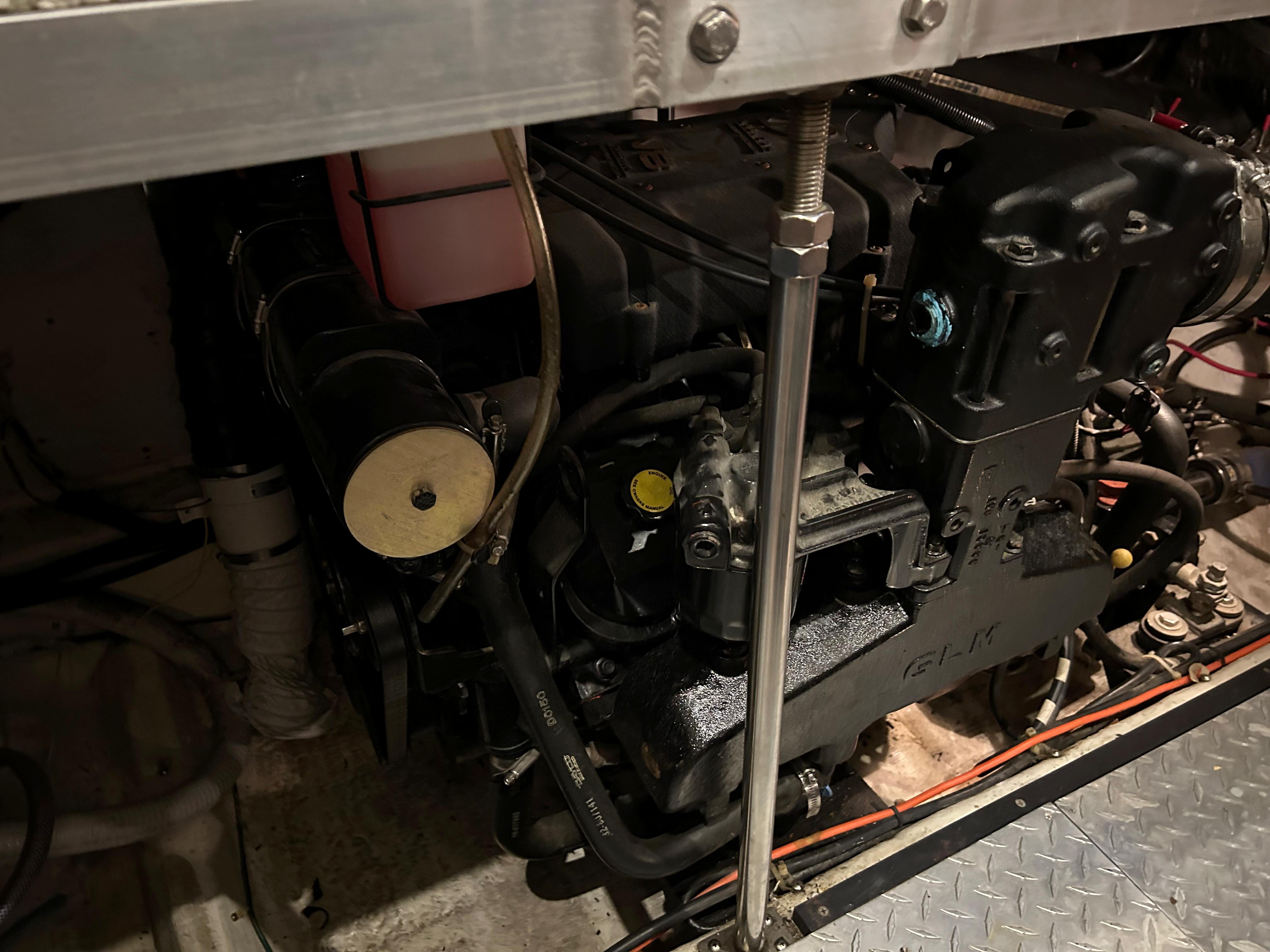 Engine compartment of a 2000 Carver 396 boat, showcasing mechanical components and wiring.