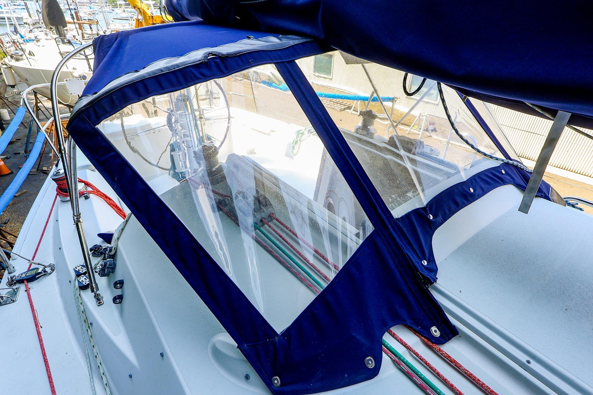 2001 J Boats J/32 sailboat cockpit with blue canvas cover and visible rigging.