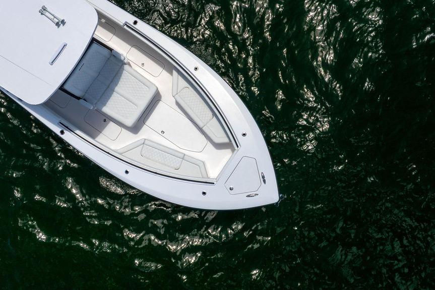 Aerial view of 2027 Reef Runner 340 boat on shimmering water.