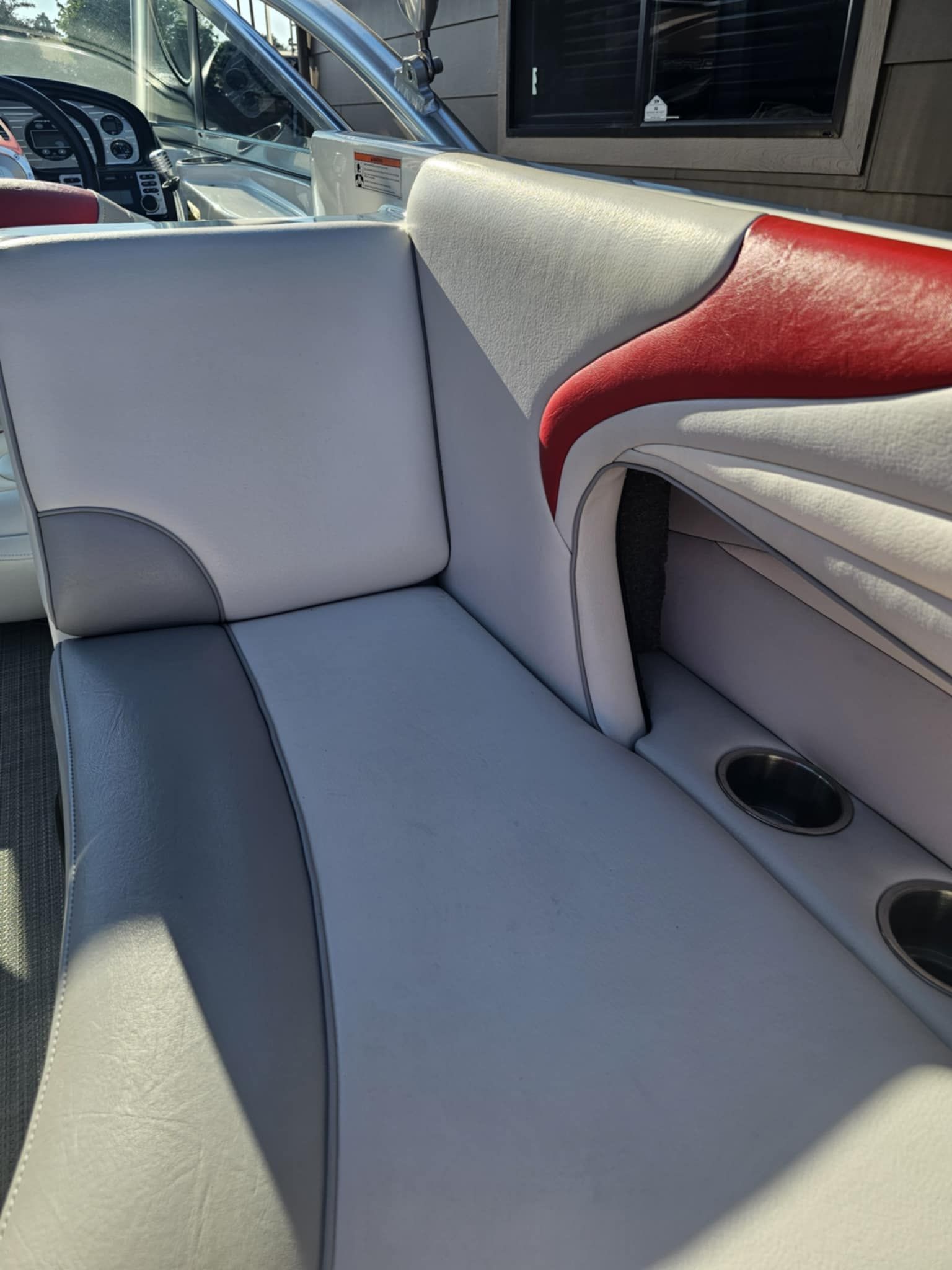 Interior of a 2006 MB PIGPR boat with gray and red seating.