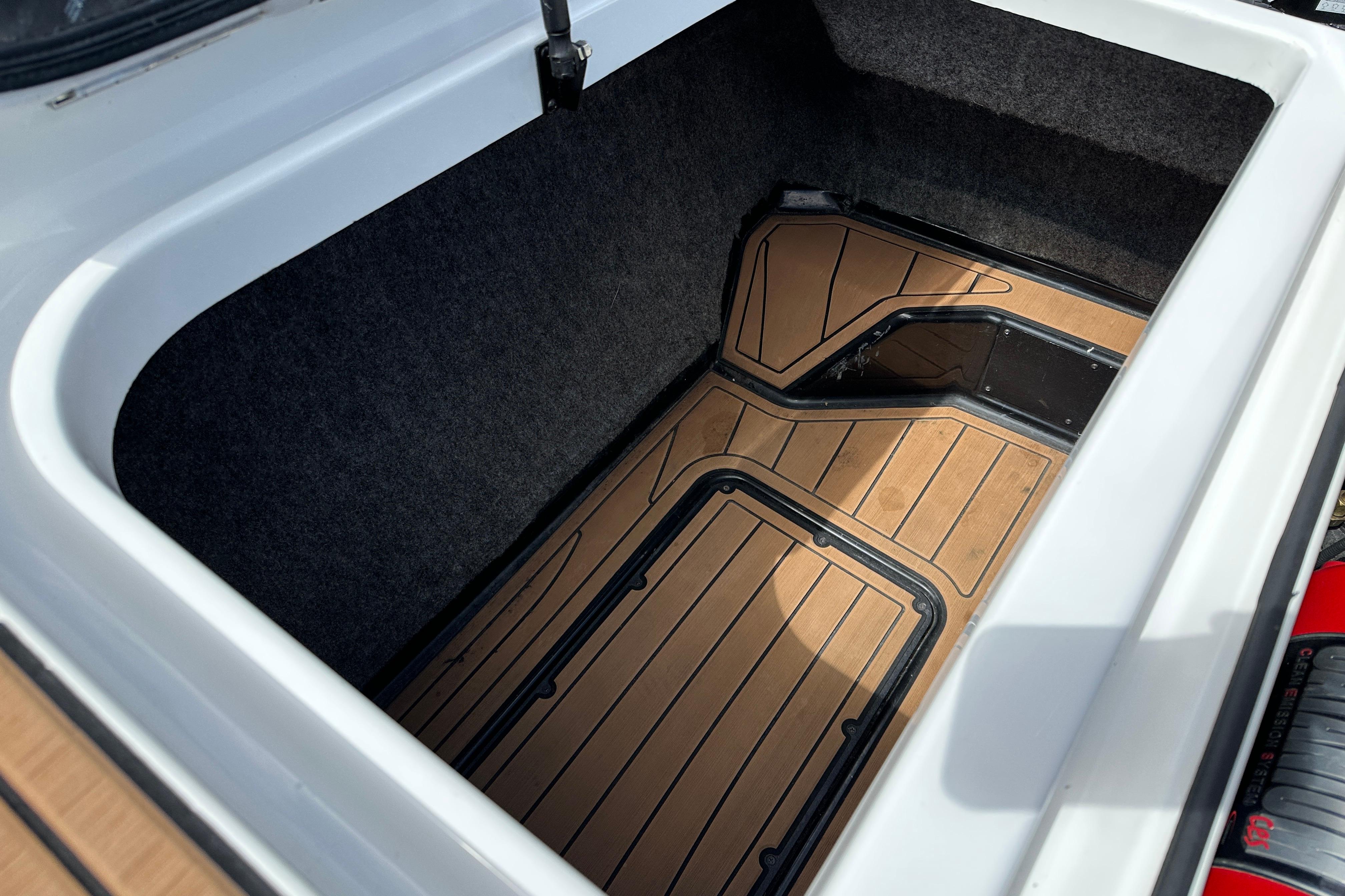 2017 Nautique Super Air Nautique GS20 storage compartment with teak flooring detail.