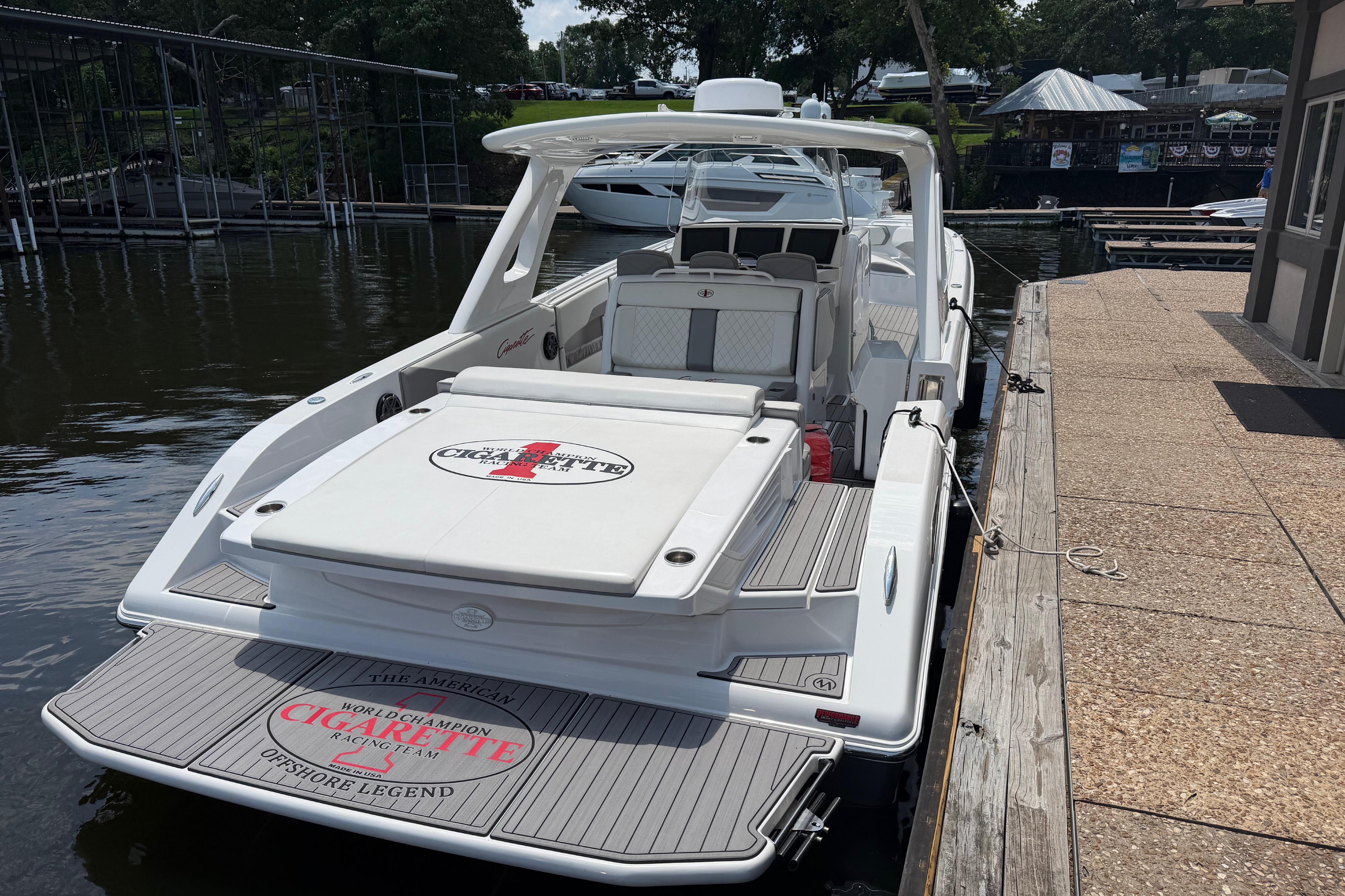2015 Cigarette 41' Nighthawk SD Edition docked, showcasing sleek design and spacious deck.