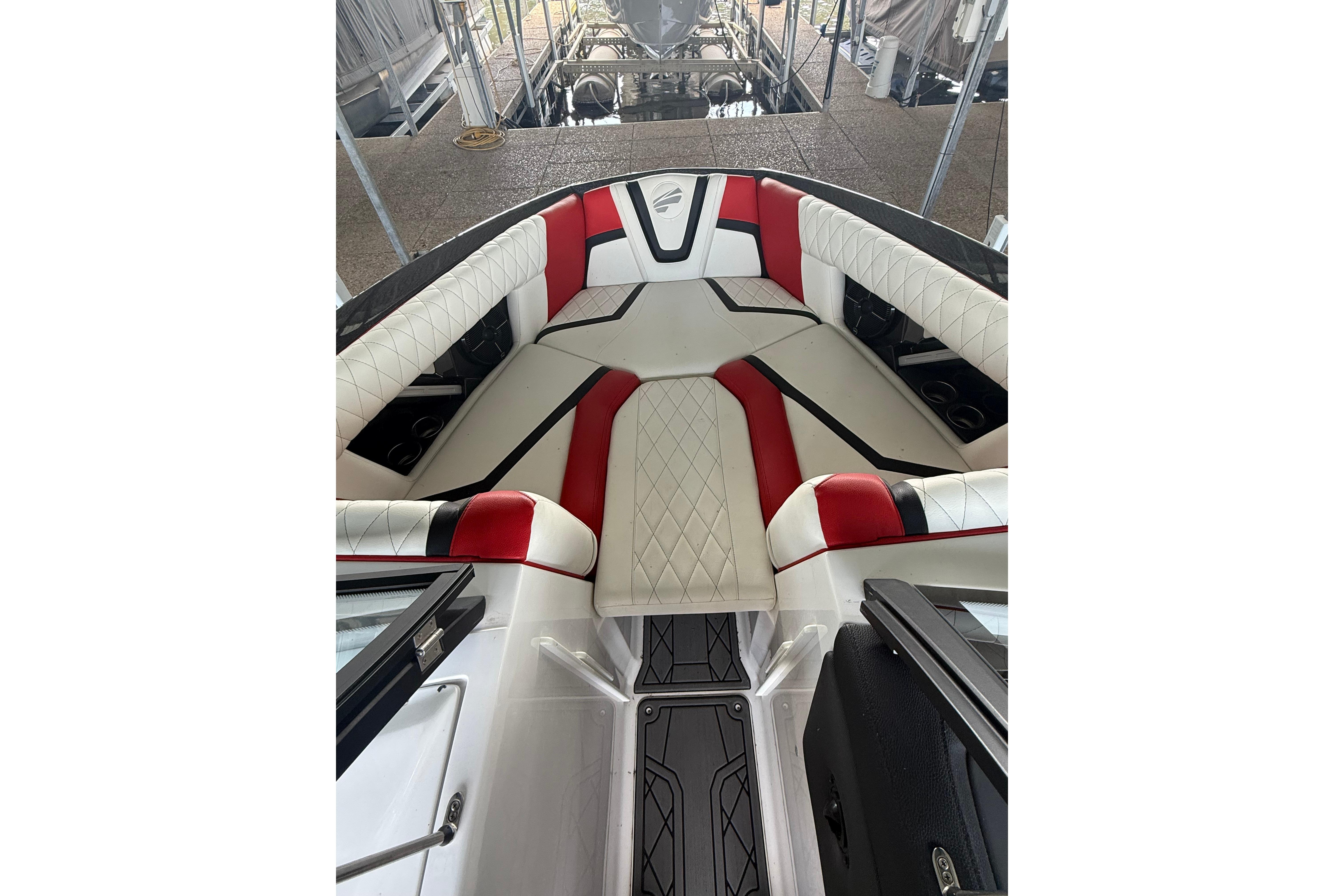 2020 Tige 25ZX boat interior with red and white seating, docked in a marina.
