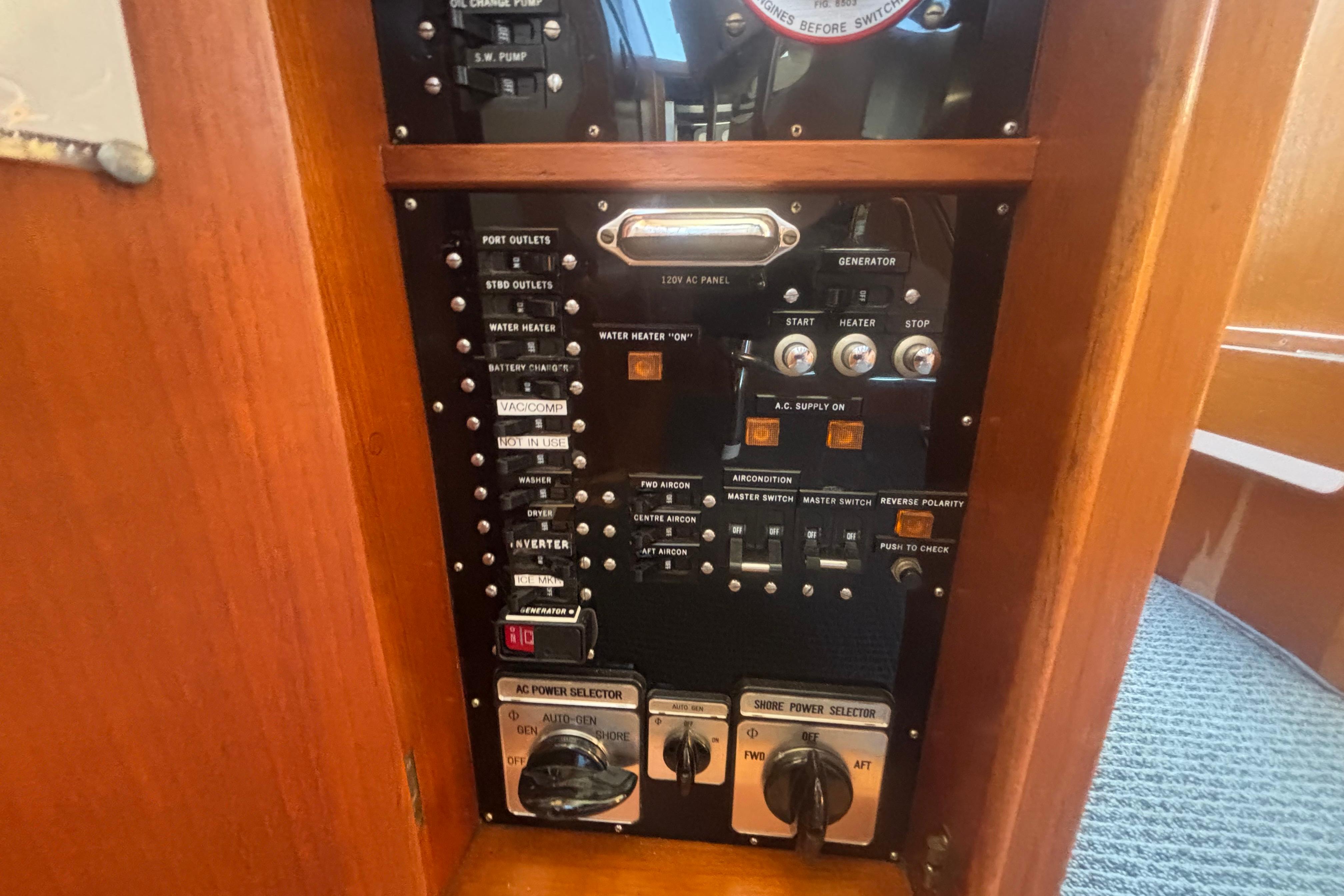 Control panel of a 1989 Grand Banks 46 Classic yacht, featuring various switches and dials.