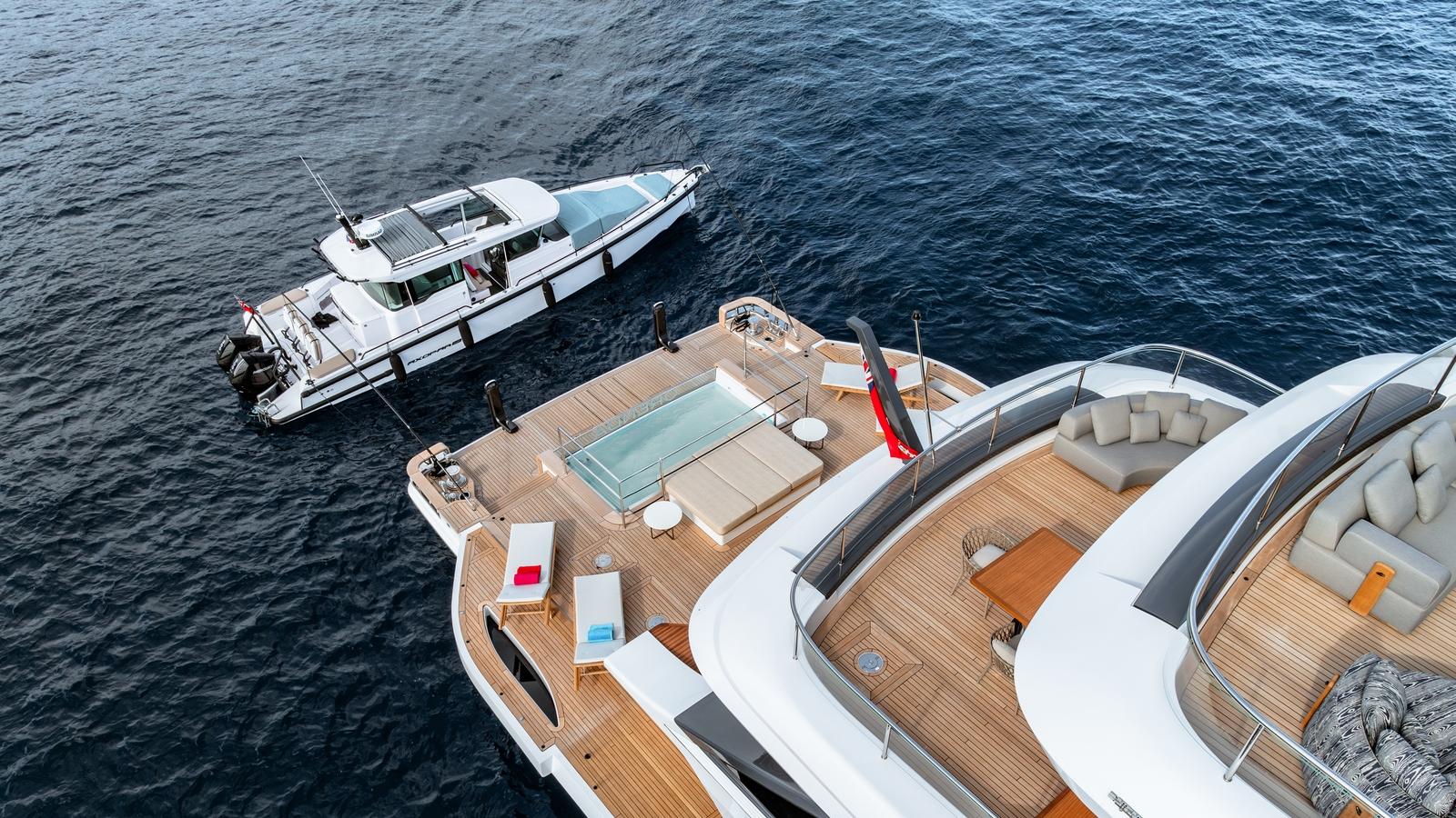 Luxurious Axopar 37 XC Cross Cabin yacht, 2024 model, docked beside a spacious deck on the water.