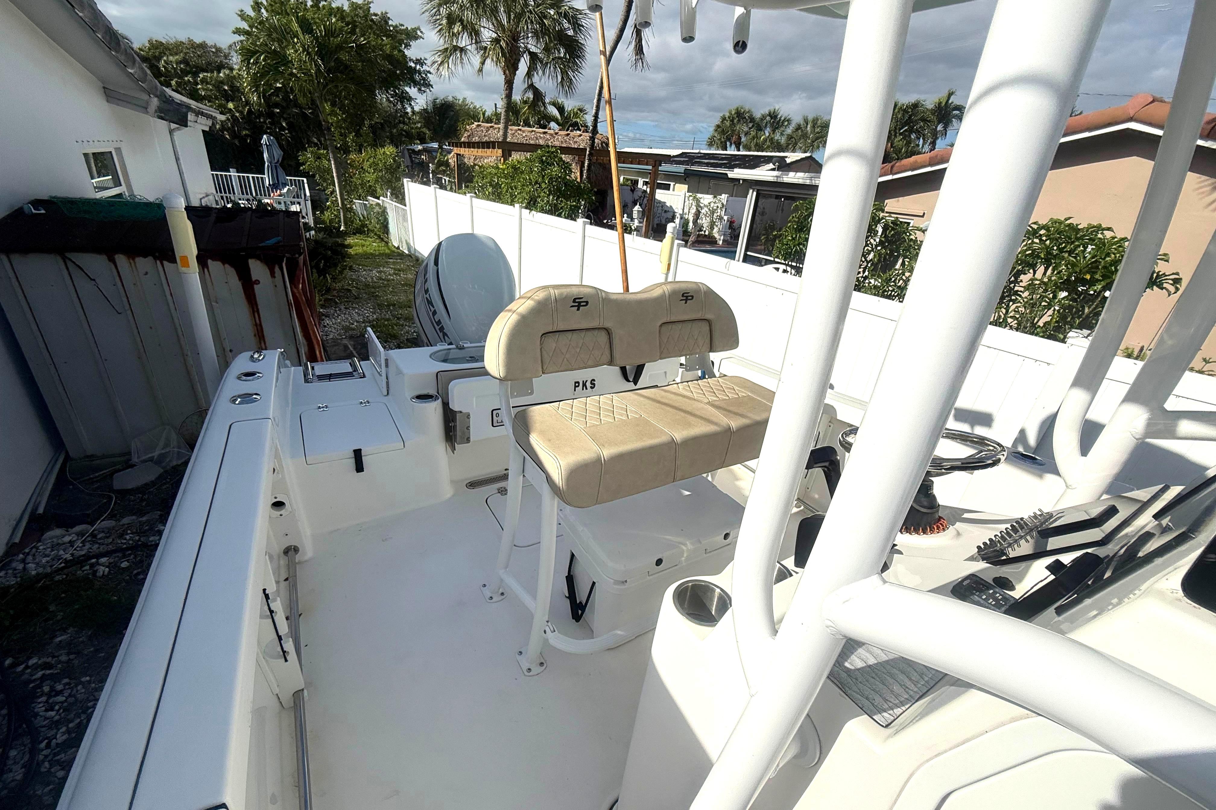 2023 Sea Pro 219 Deep V CC boat interior with seating and console, parked outdoors.