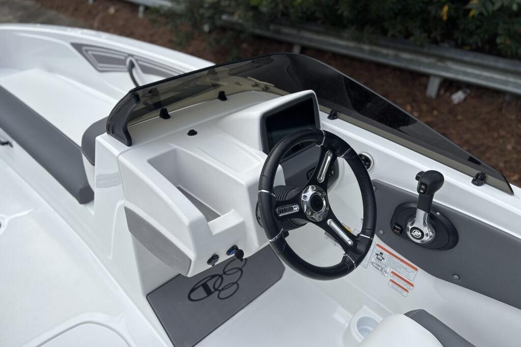 2026 Tahoe T21 boat cockpit with steering wheel and control panel.