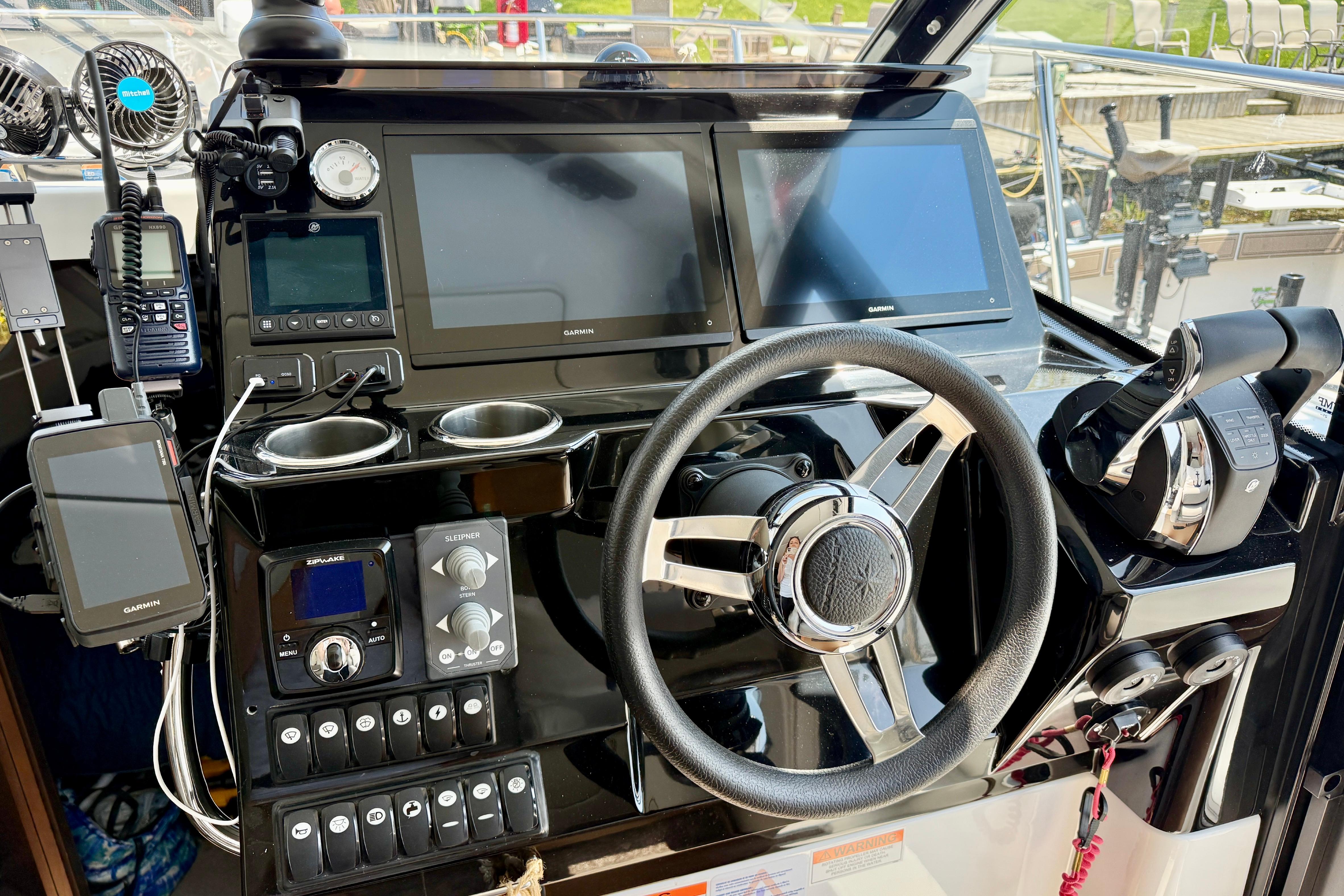 Cockpit of 2022 Jeanneau NC 1095 Fly with advanced navigation equipment and controls.