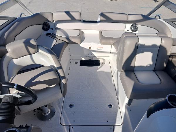 2010 Yamaha Boats 242 Limited interior with seating and steering wheel.
