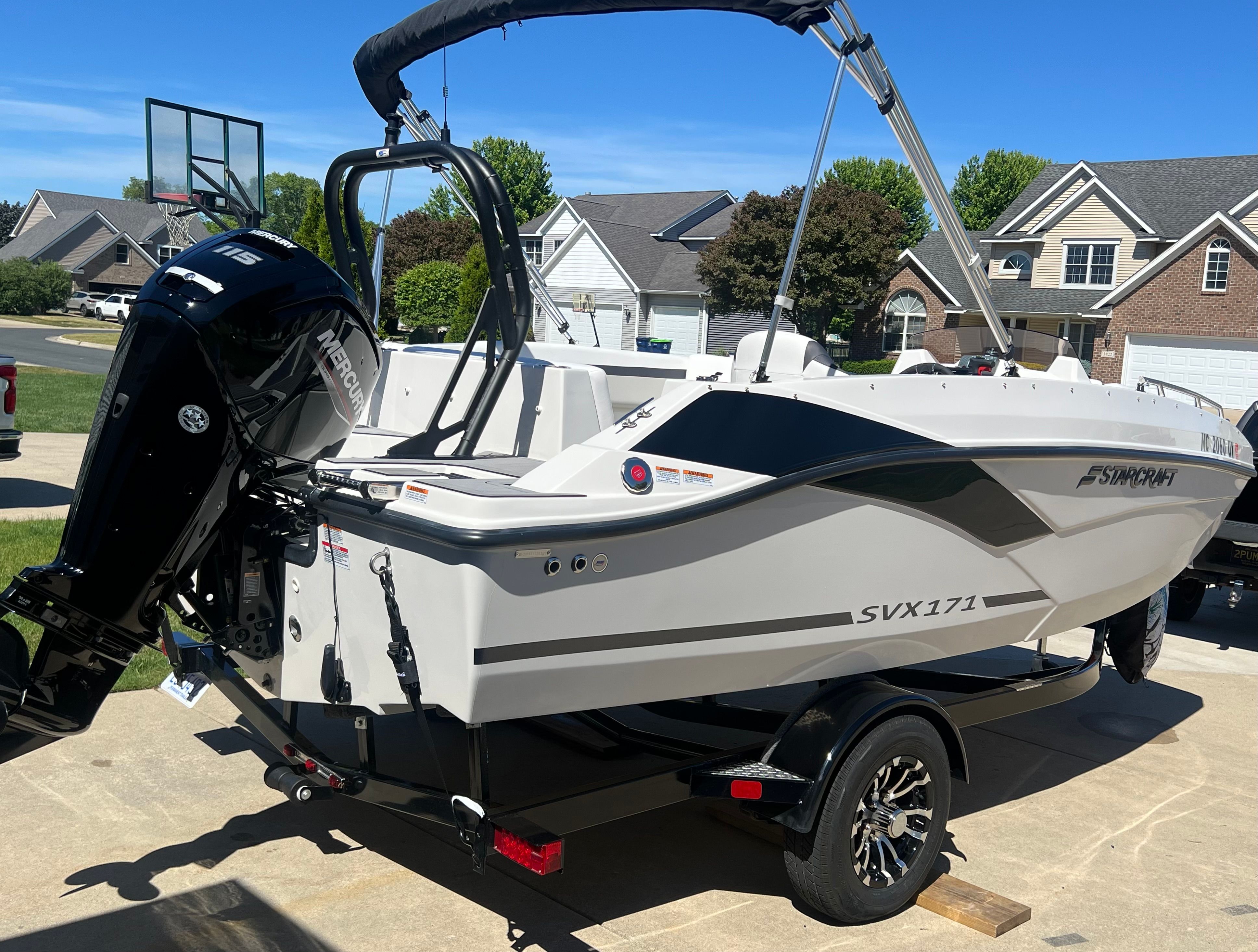 2023 Starcraft SVX 171 OB boat on trailer in residential area.
