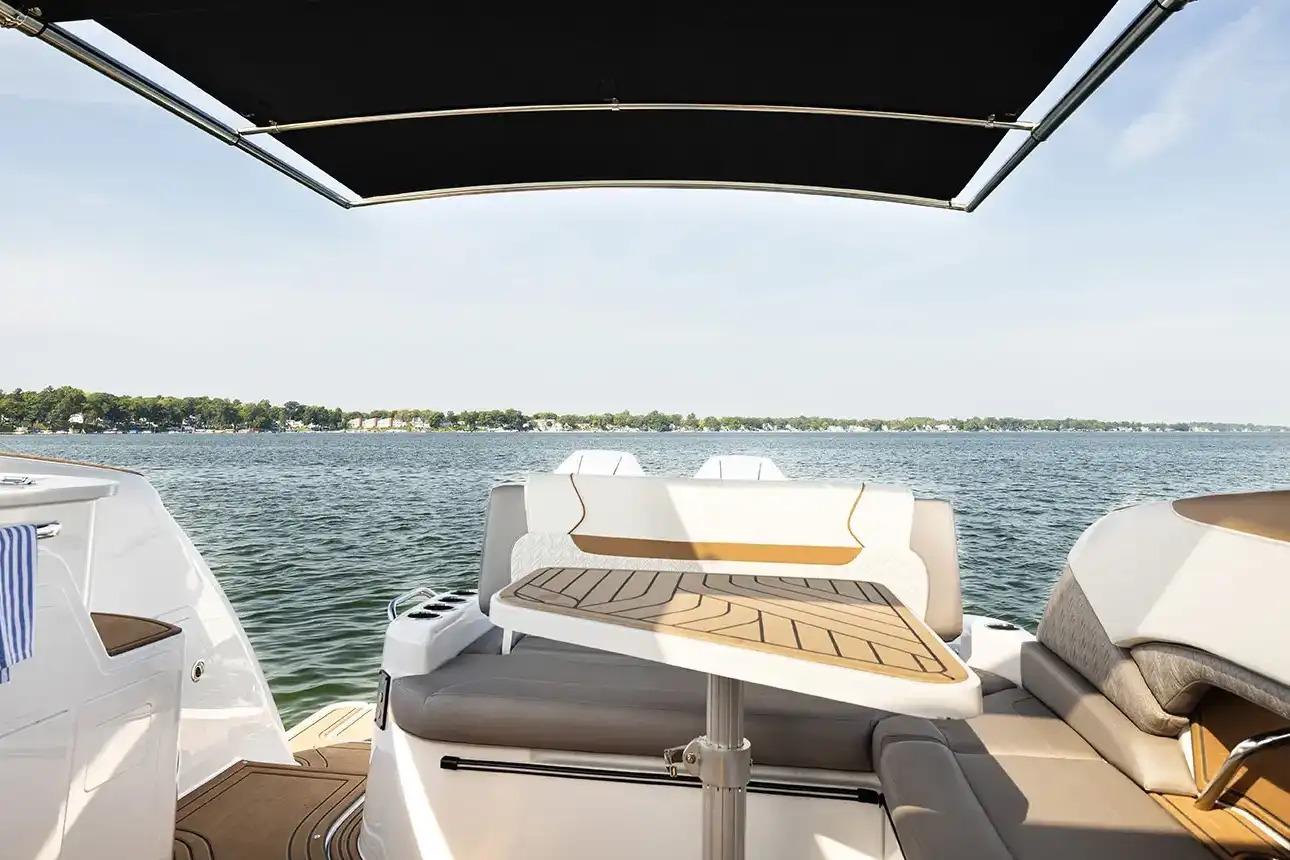 Manufacturer Provided Image: 2026 Hurricane SunDeck 3200 OB boat interior with lake view, featuring seating and table.