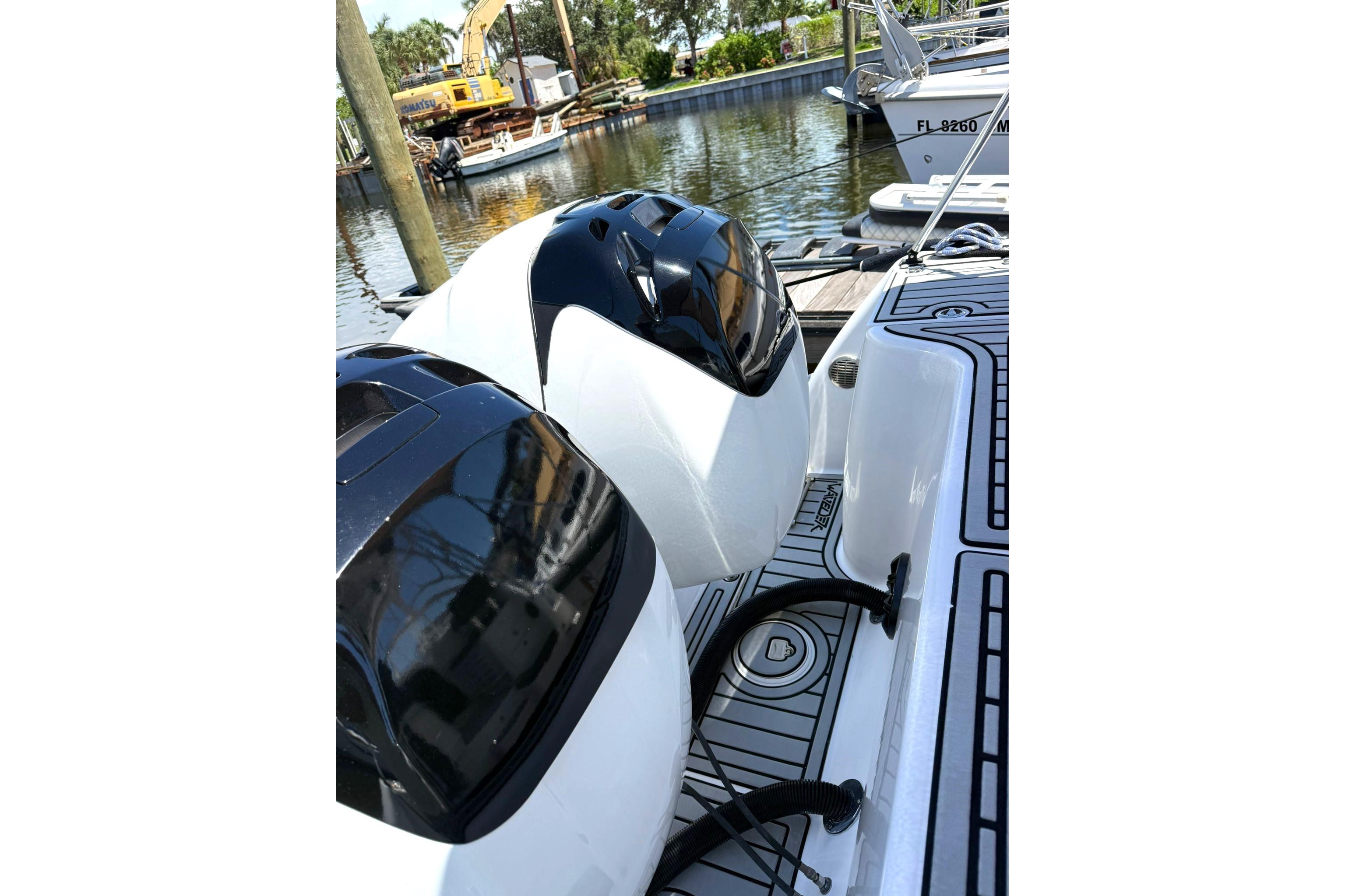 2006 Pro-Line 32 Express boat engines docked by the water.