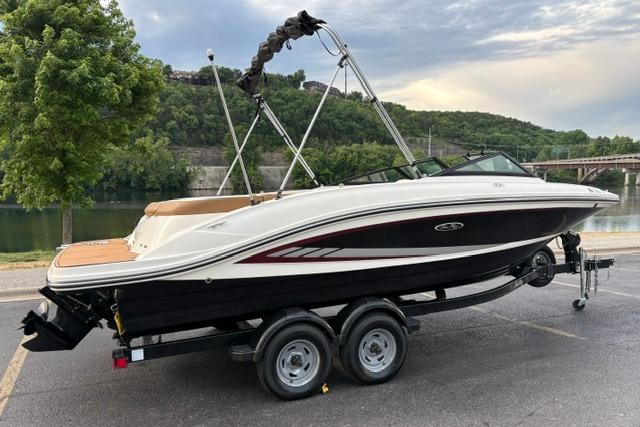 2017 Searay SPX210 boat on trailer by riverside, scenic background.